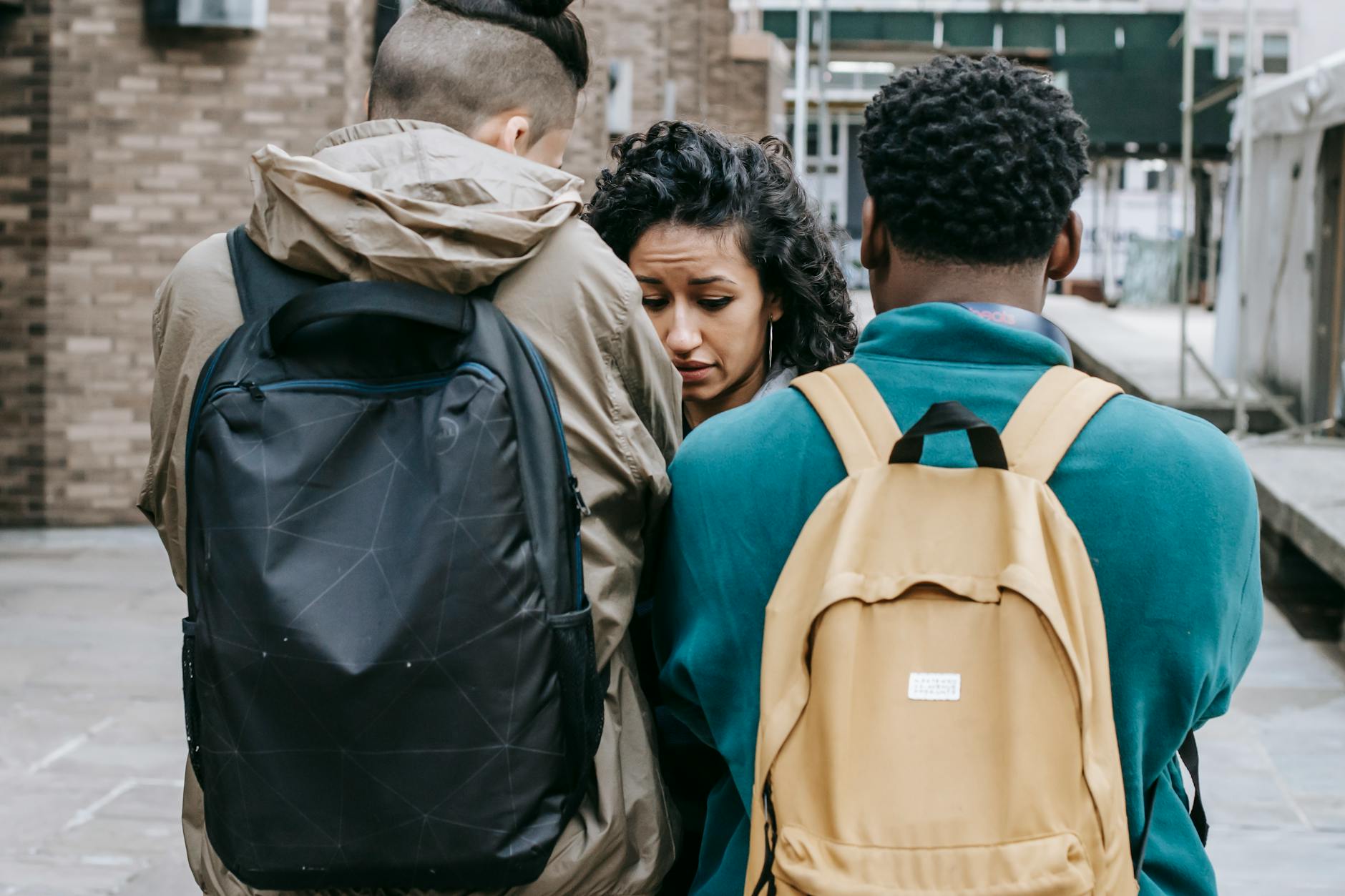 A tense interaction between diverse university students outdoors, showcasing conflict and emotion. - winter social anxiety