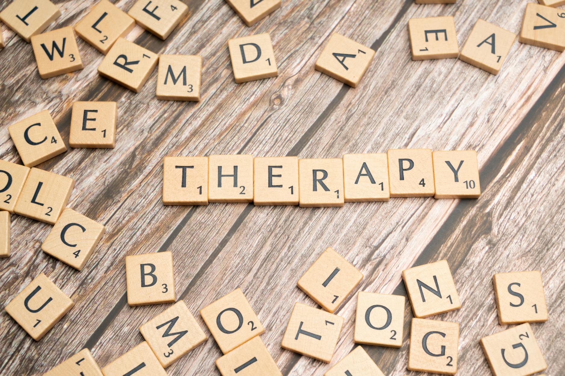 Wooden letter tiles spelling 'therapy' on a wooden background, emphasizing mental health. - winter therapy motivation