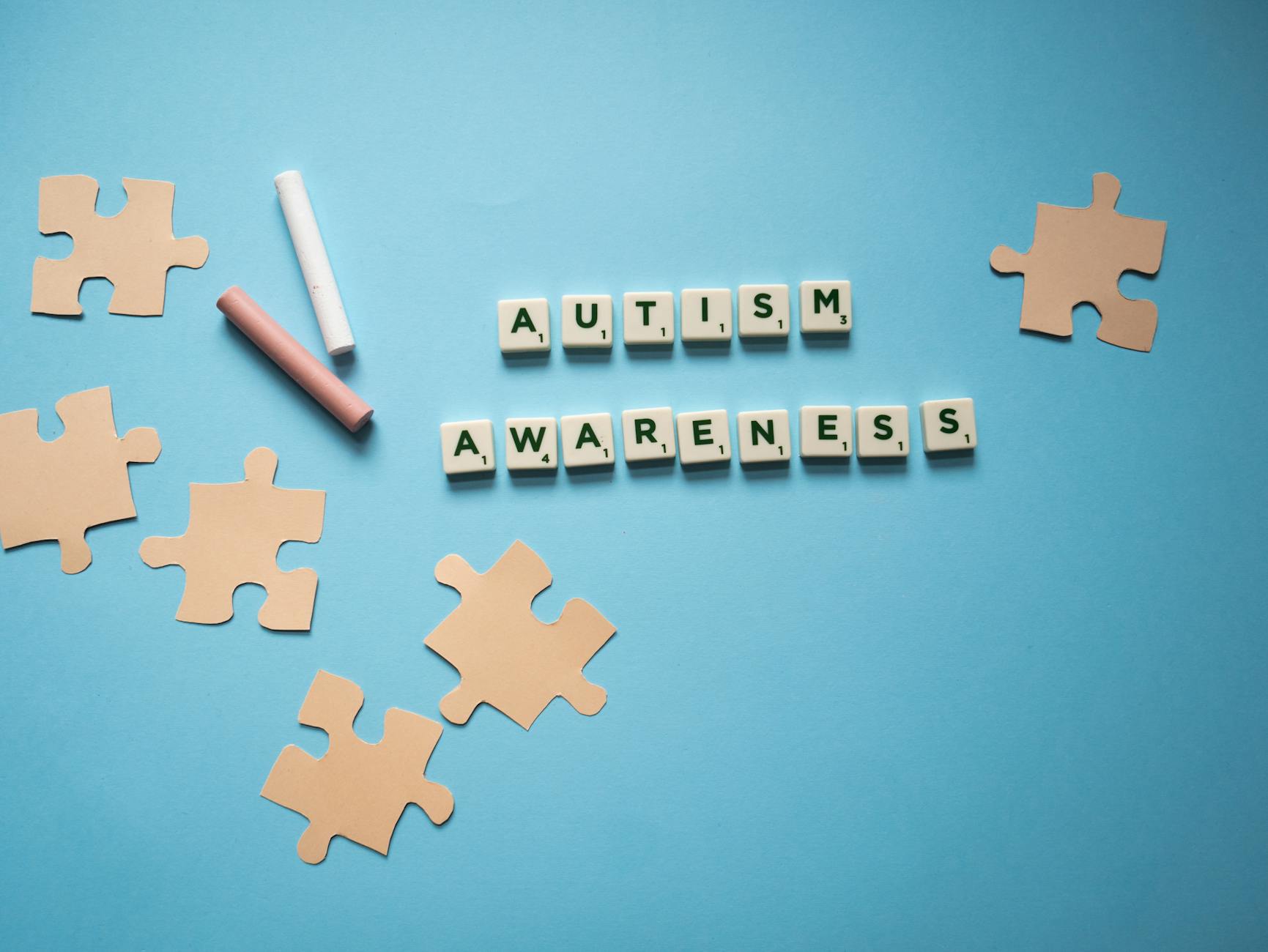 Creative autism awareness concept with puzzle pieces on a blue background. - acceptance and commitment therapy spring