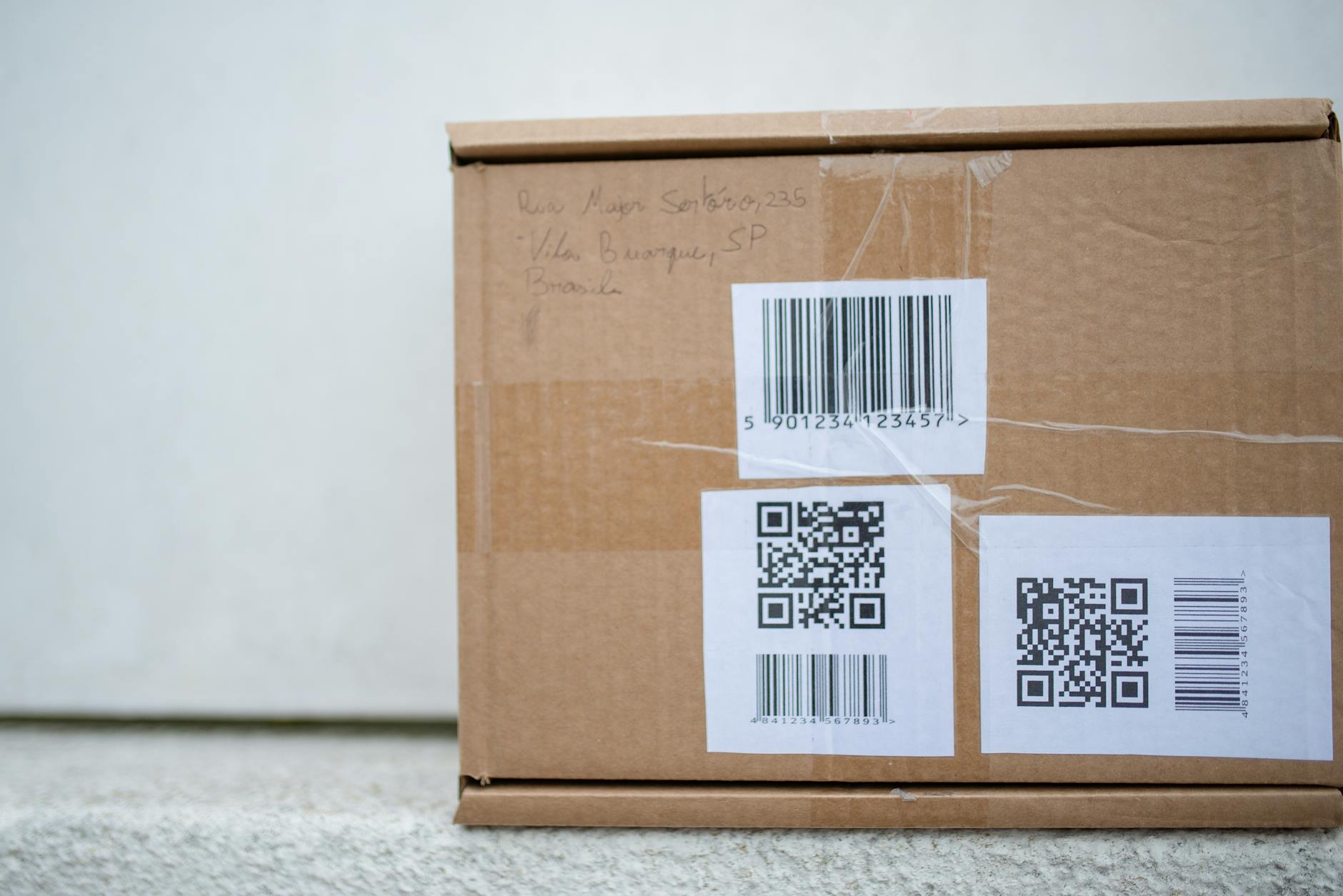 Close-up of a cardboard package with QR codes and a barcode, ideal for delivery and shipping concepts. - address unspoken issues