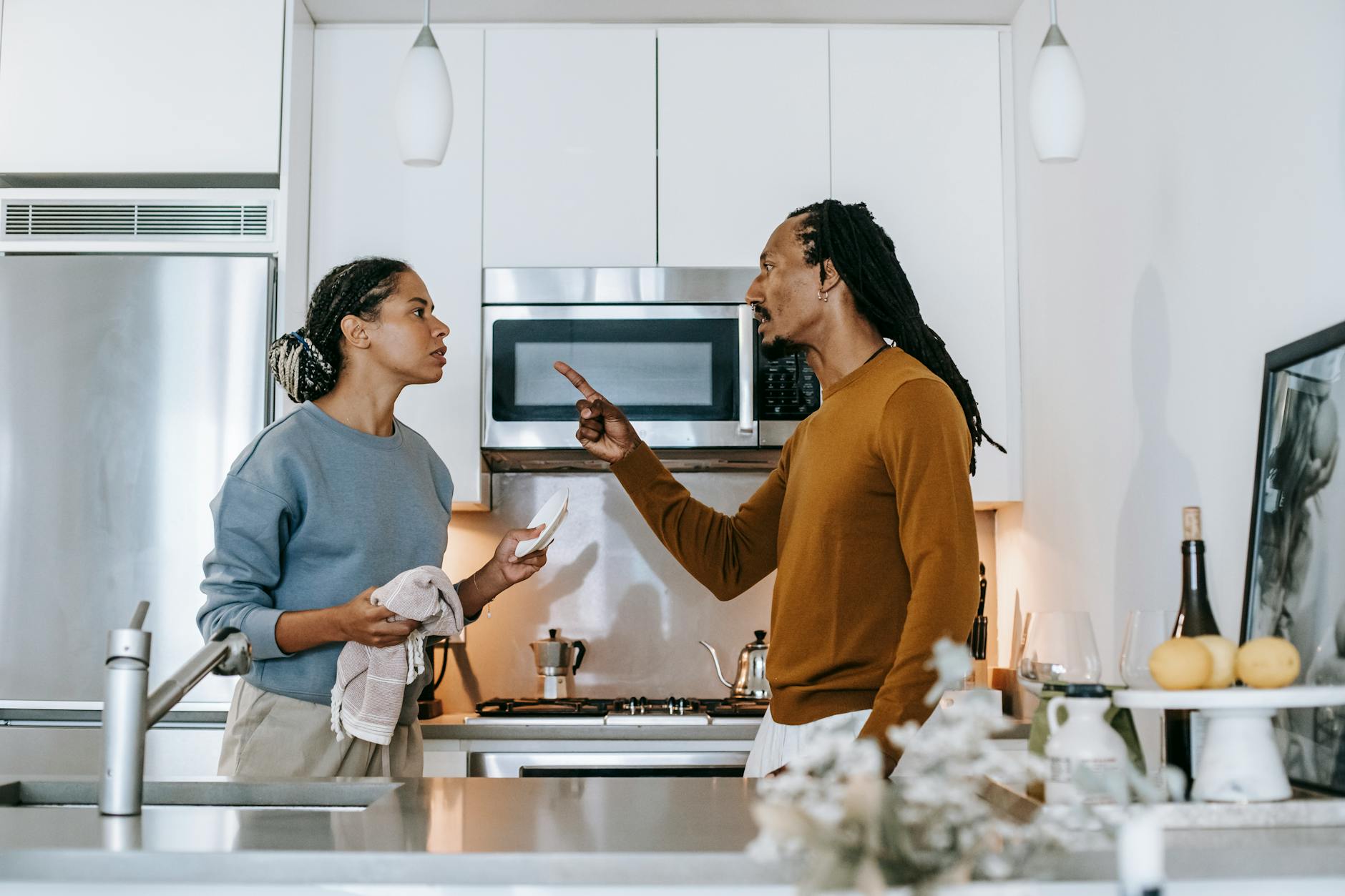 A couple in a heated discussion in a stylish kitchen, emphasizing relationship dynamics. - allergy irritability relationship