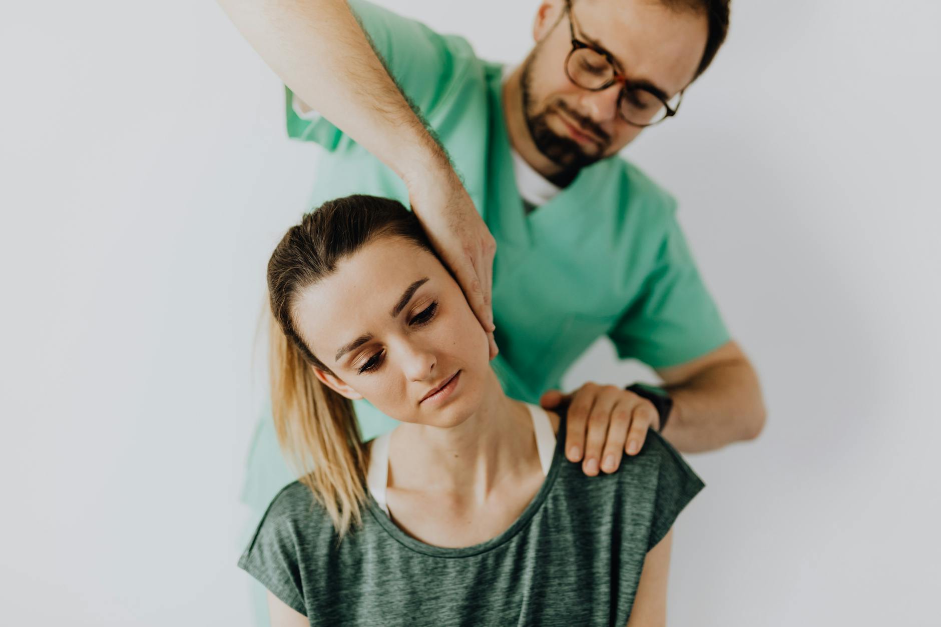 Professional chiropractor treating a woman's neck pain with therapeutic techniques. - allergy relationship strain