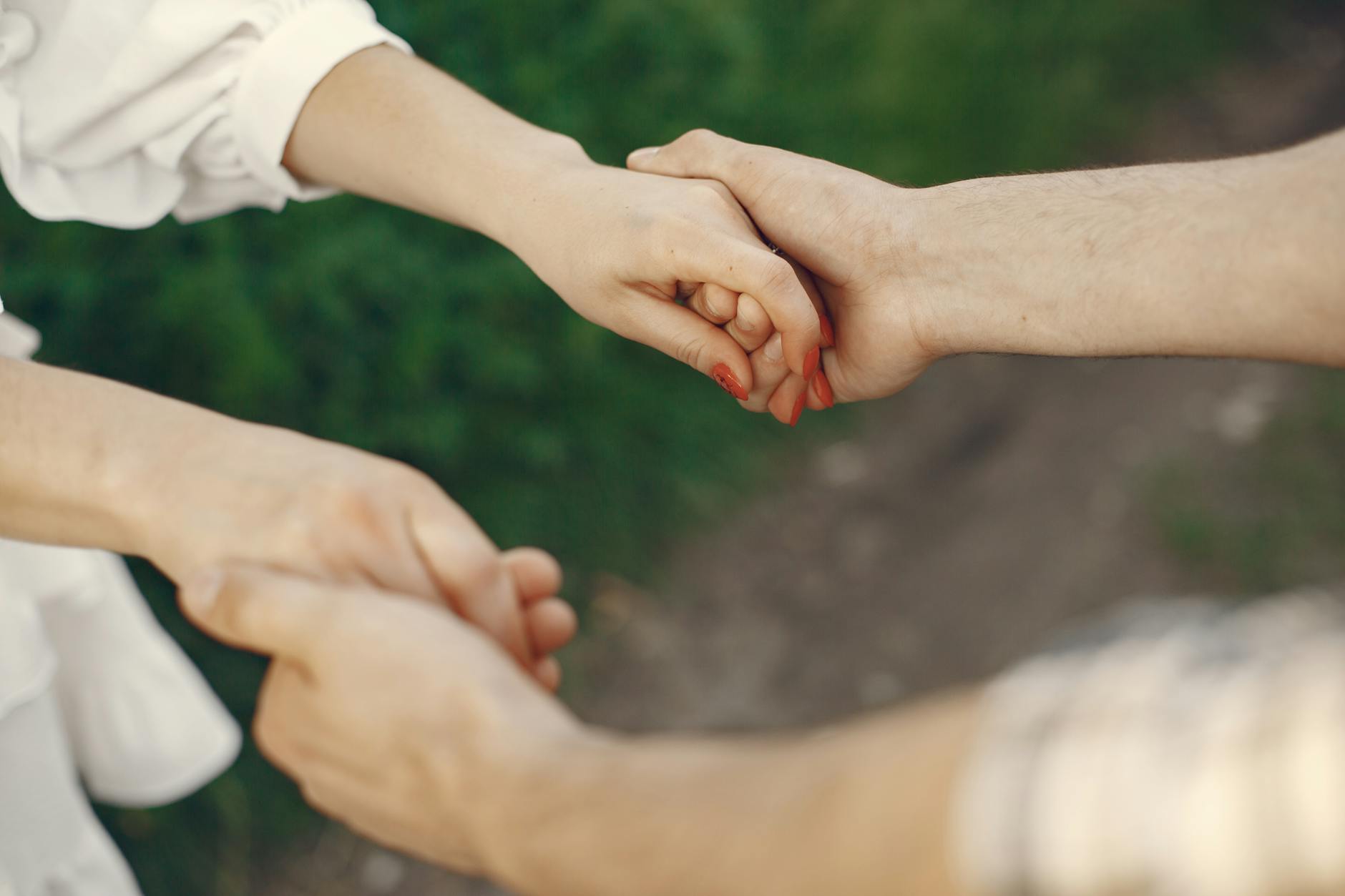 A couple holding hands in an outdoor setting symbolizing love and unity. - attachment style quiz