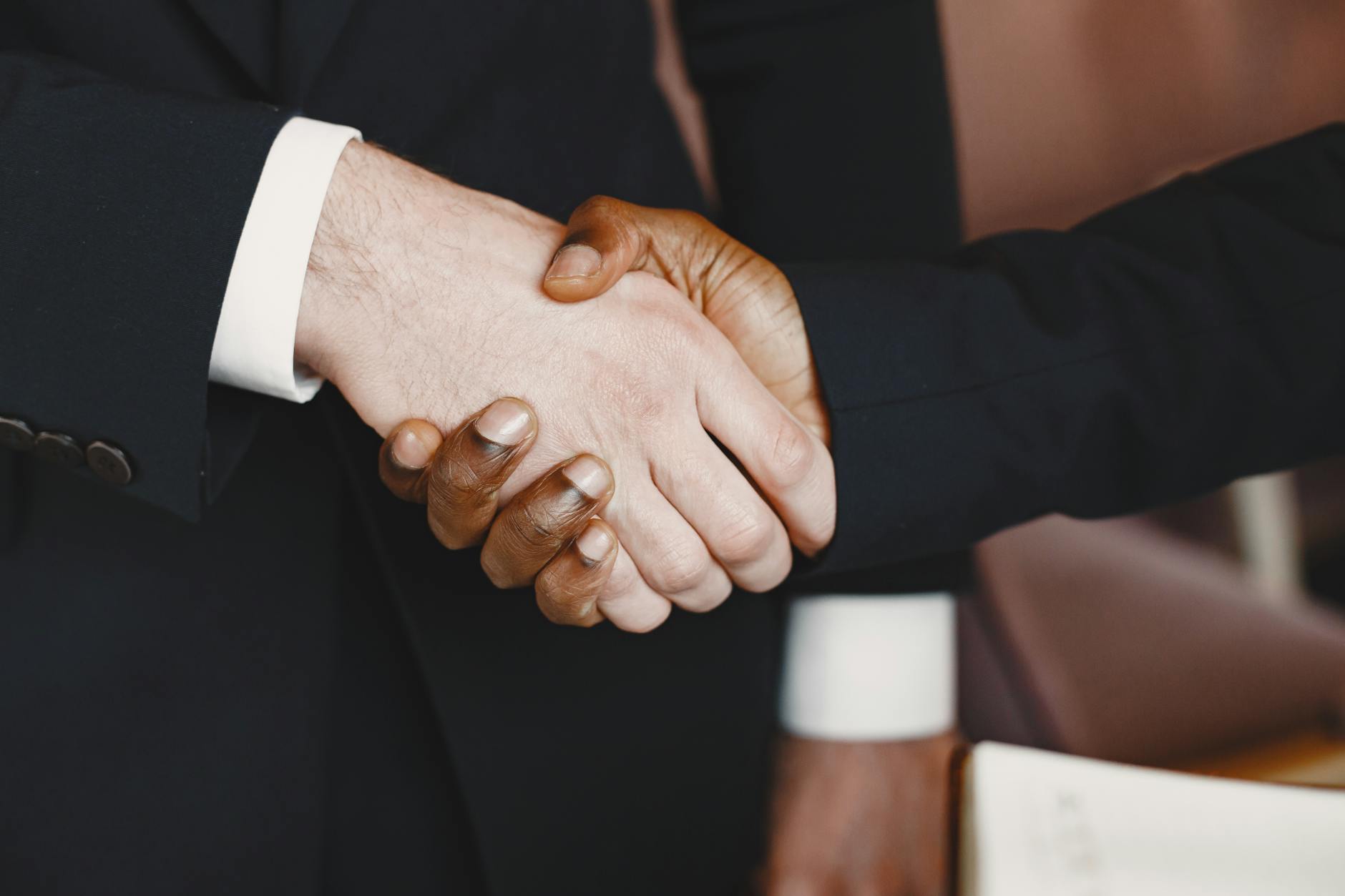 Close-up of a professional handshake symbolizing partnership and agreement. - build trust relationship