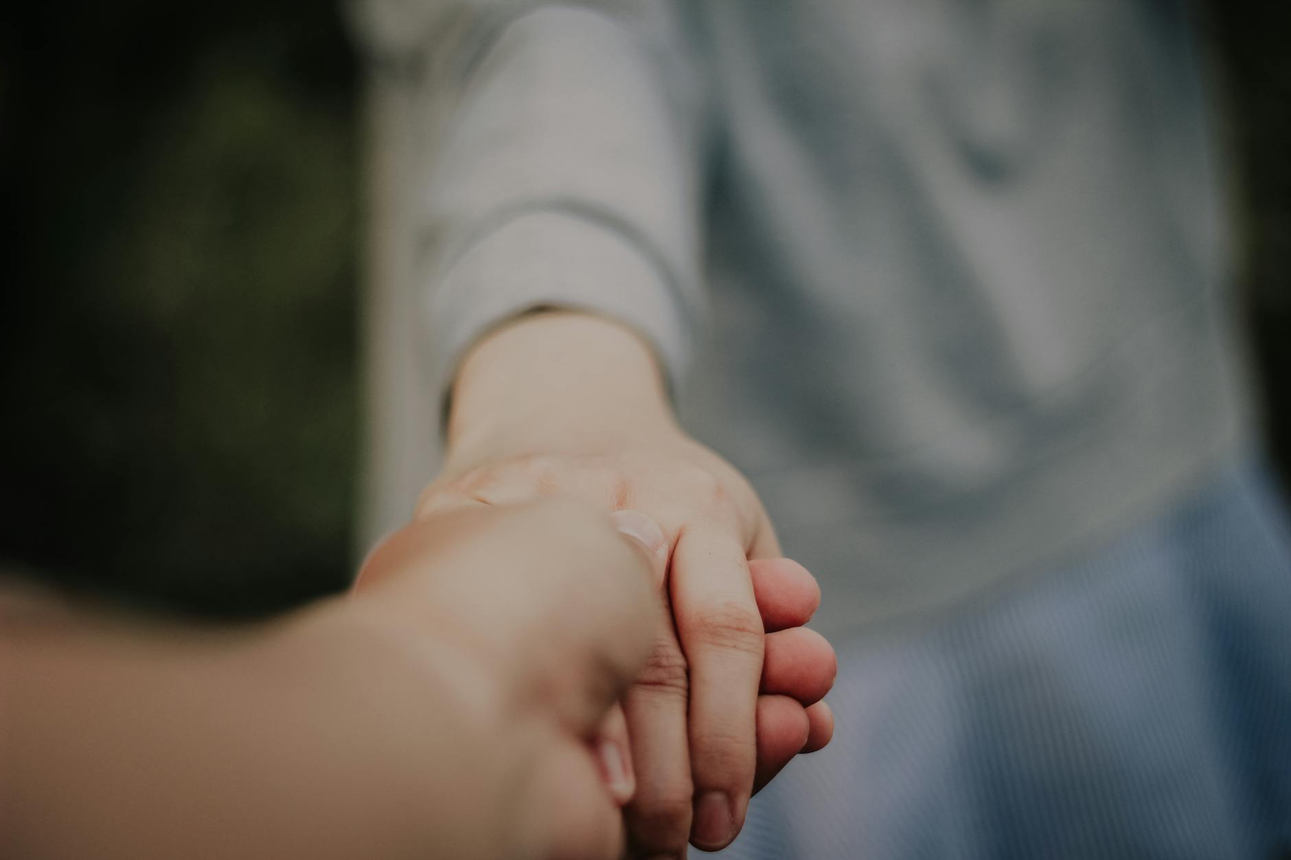 Hands holding in a gesture of connection and support, emphasizing unity and trust. - build trust relationship