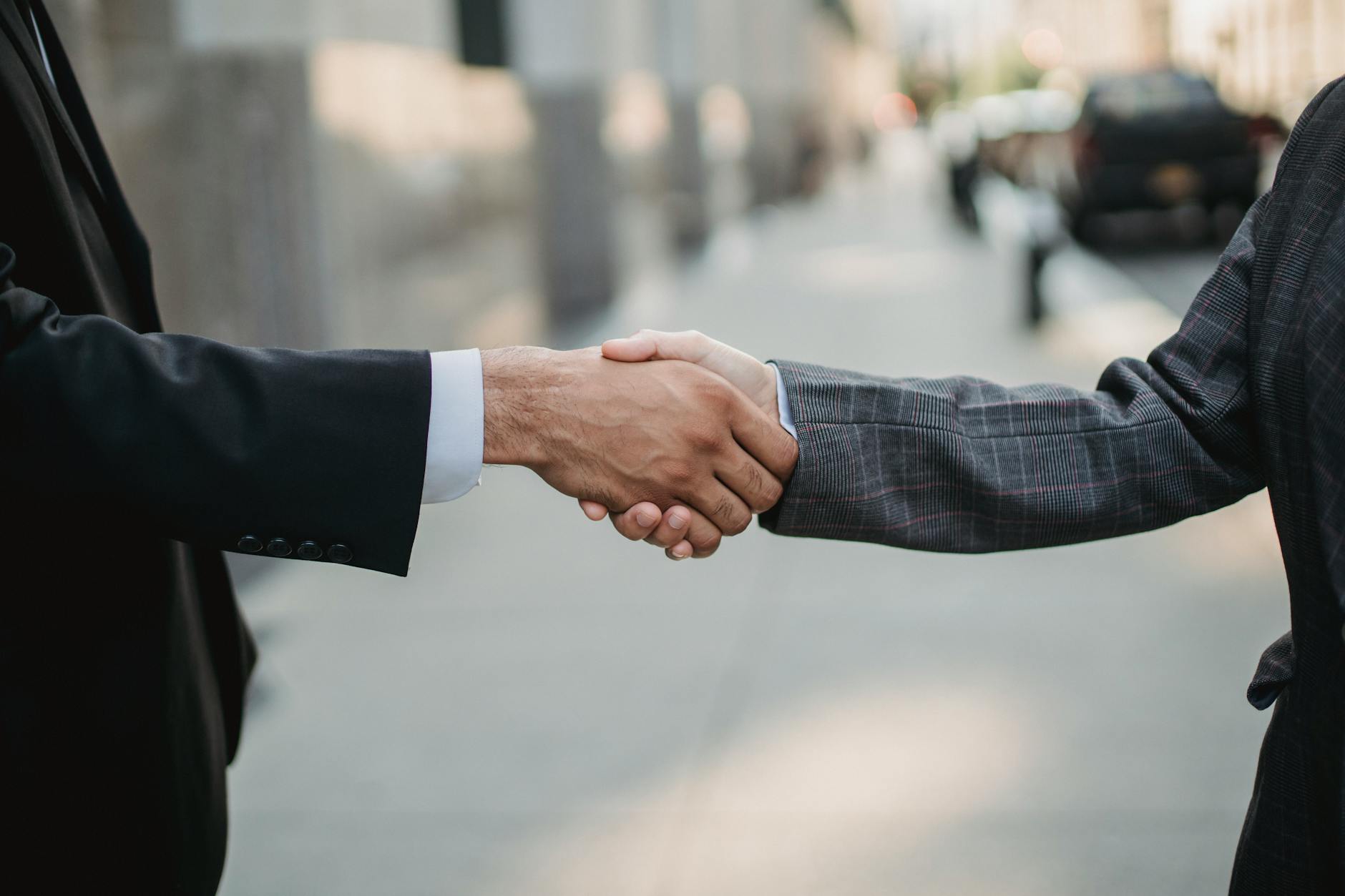 Close-up of a business handshake between professionals outdoors. - build trust relationships