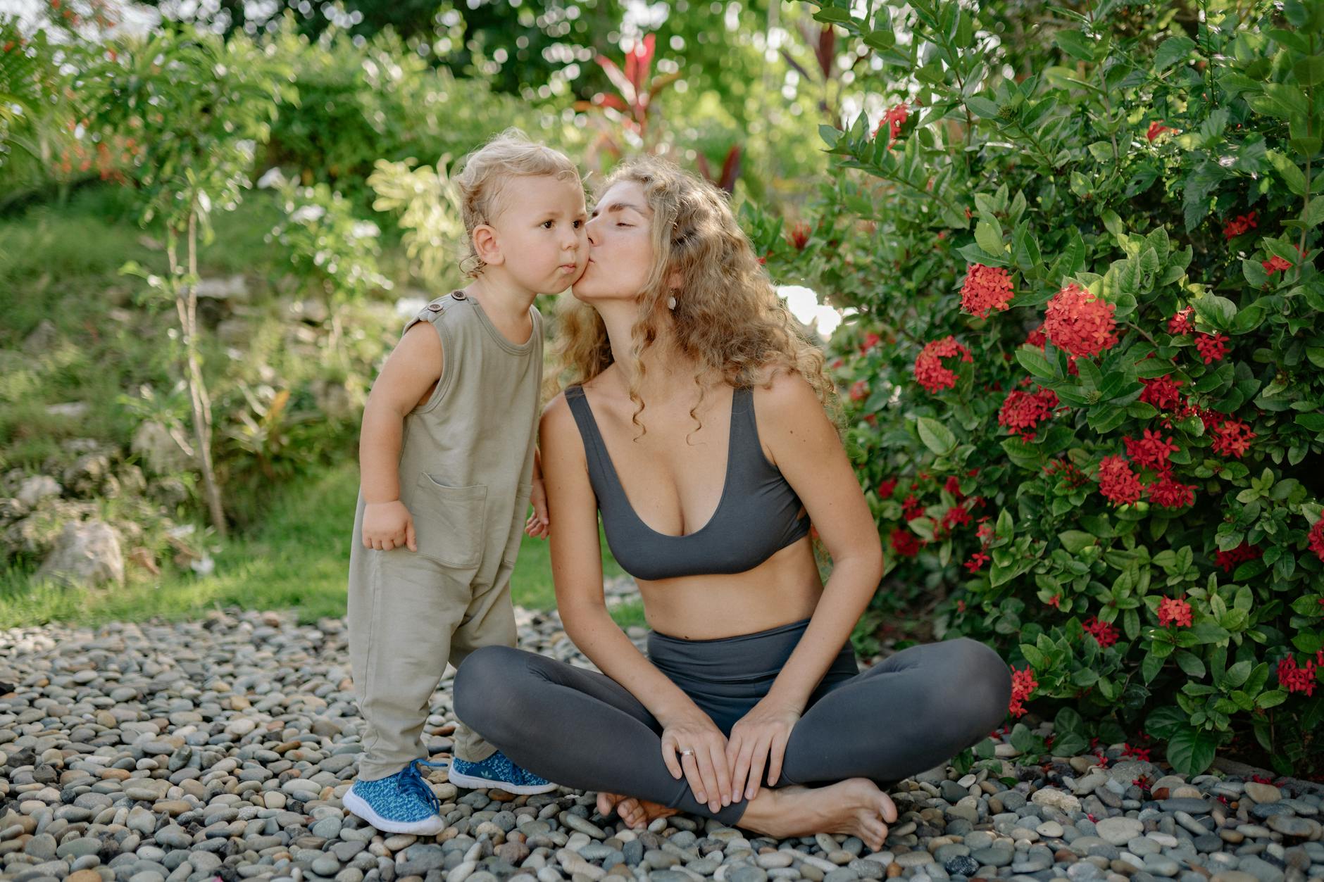 A mother and her child share a loving moment in a garden setting, emphasizing nature and wellness. - child growth spurts
