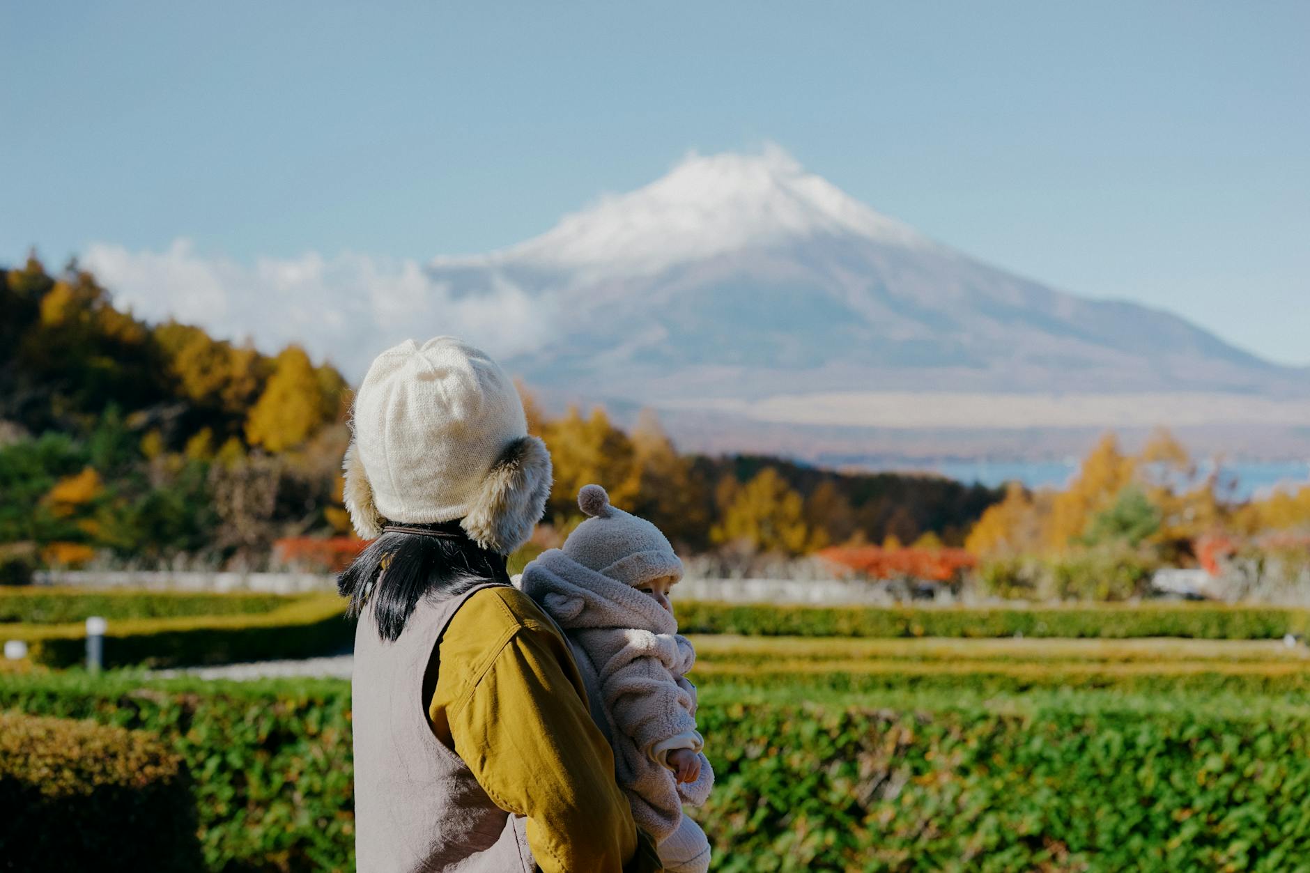 A mother and her baby enjoy a scenic autumn view of Mount Fuji in Fujinomiya, Japan. - child growth spurts