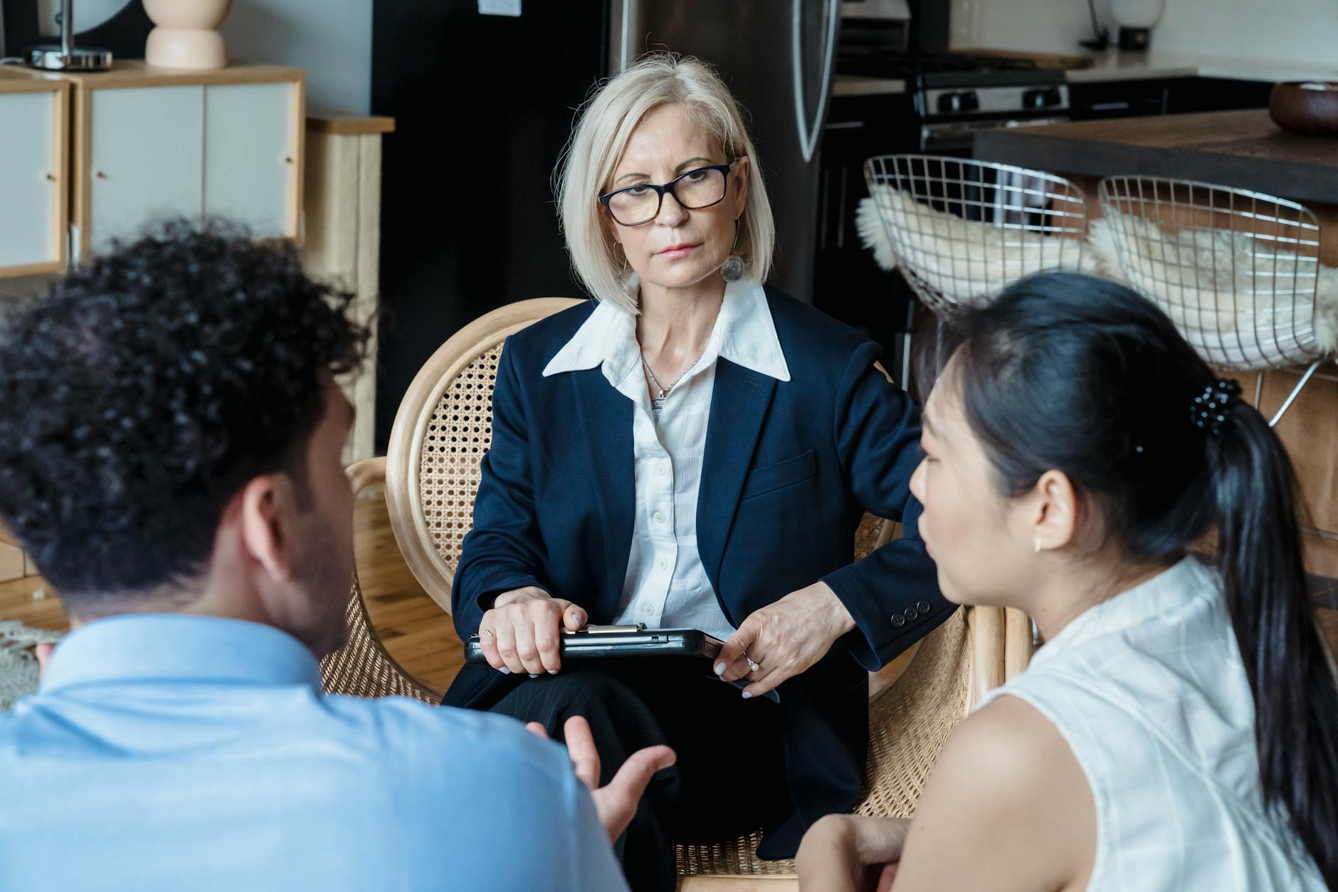 A professional therapist engages with a couple during a counseling session indoors. - couples counseling communication