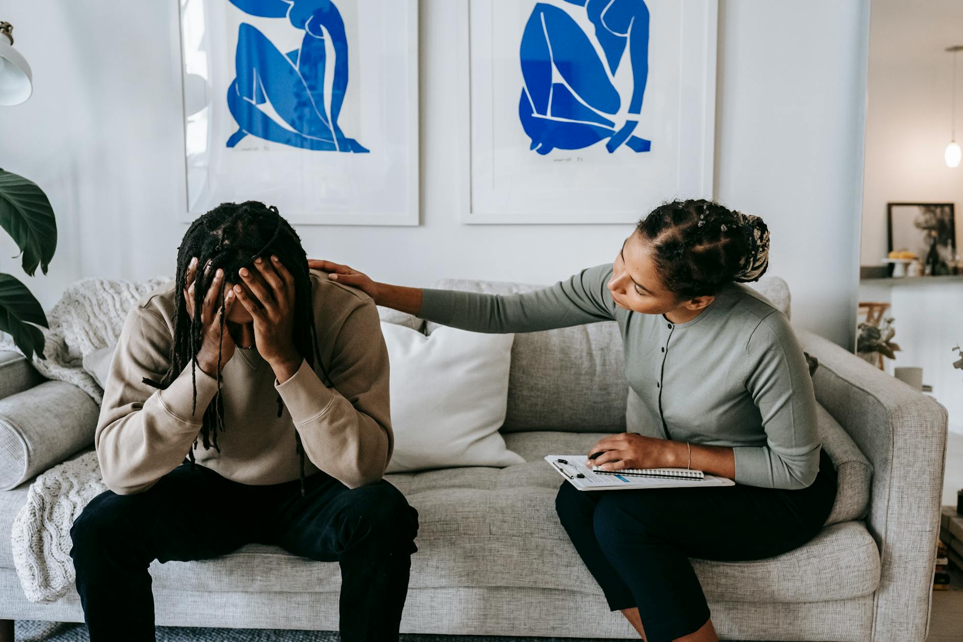 A couple sharing a moment of support and understanding on a living room sofa, depicting comfort. - couples therapy guide