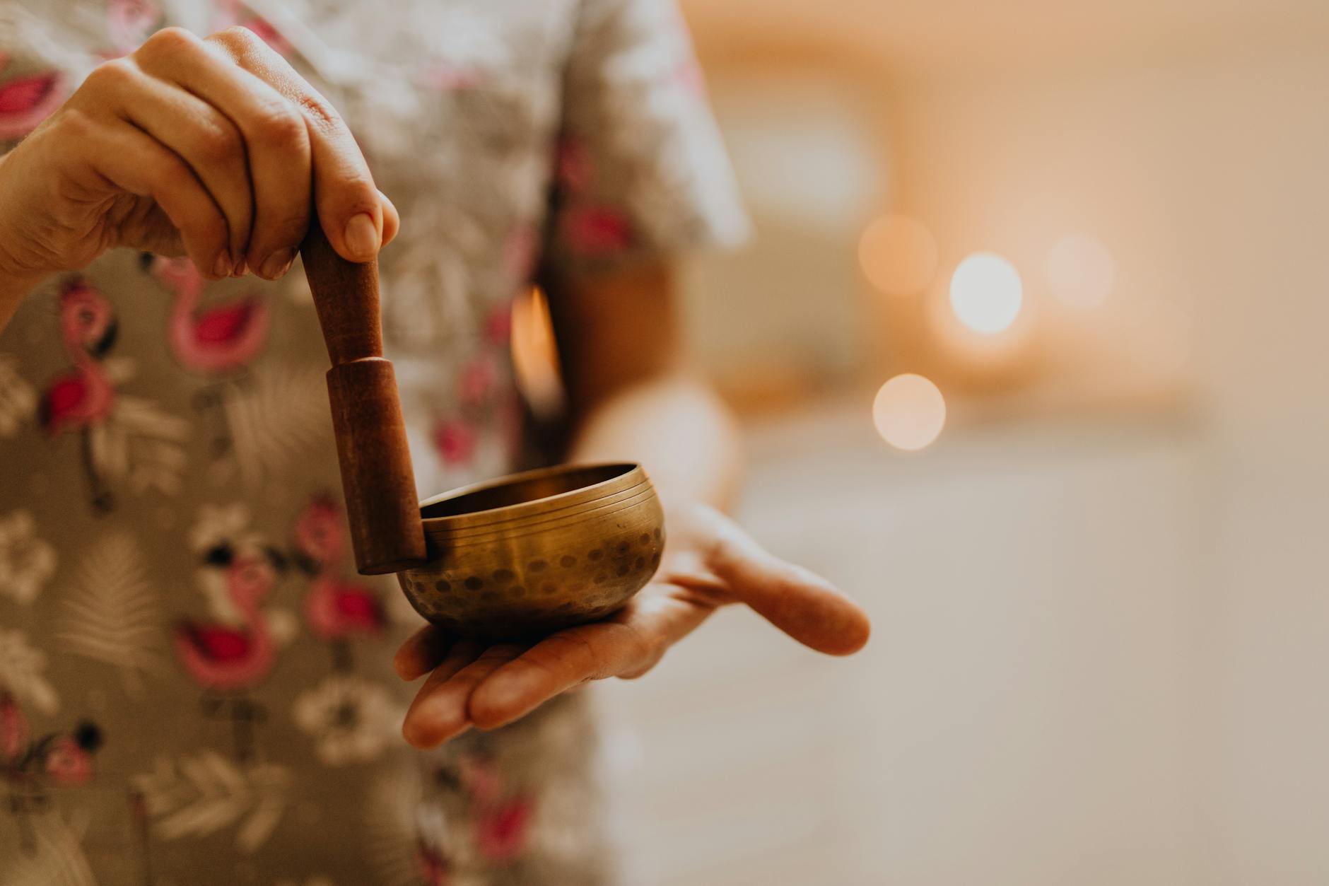 Close-up of a person using a singing bowl for meditation, promoting relaxation and wellness. - couples therapy guide