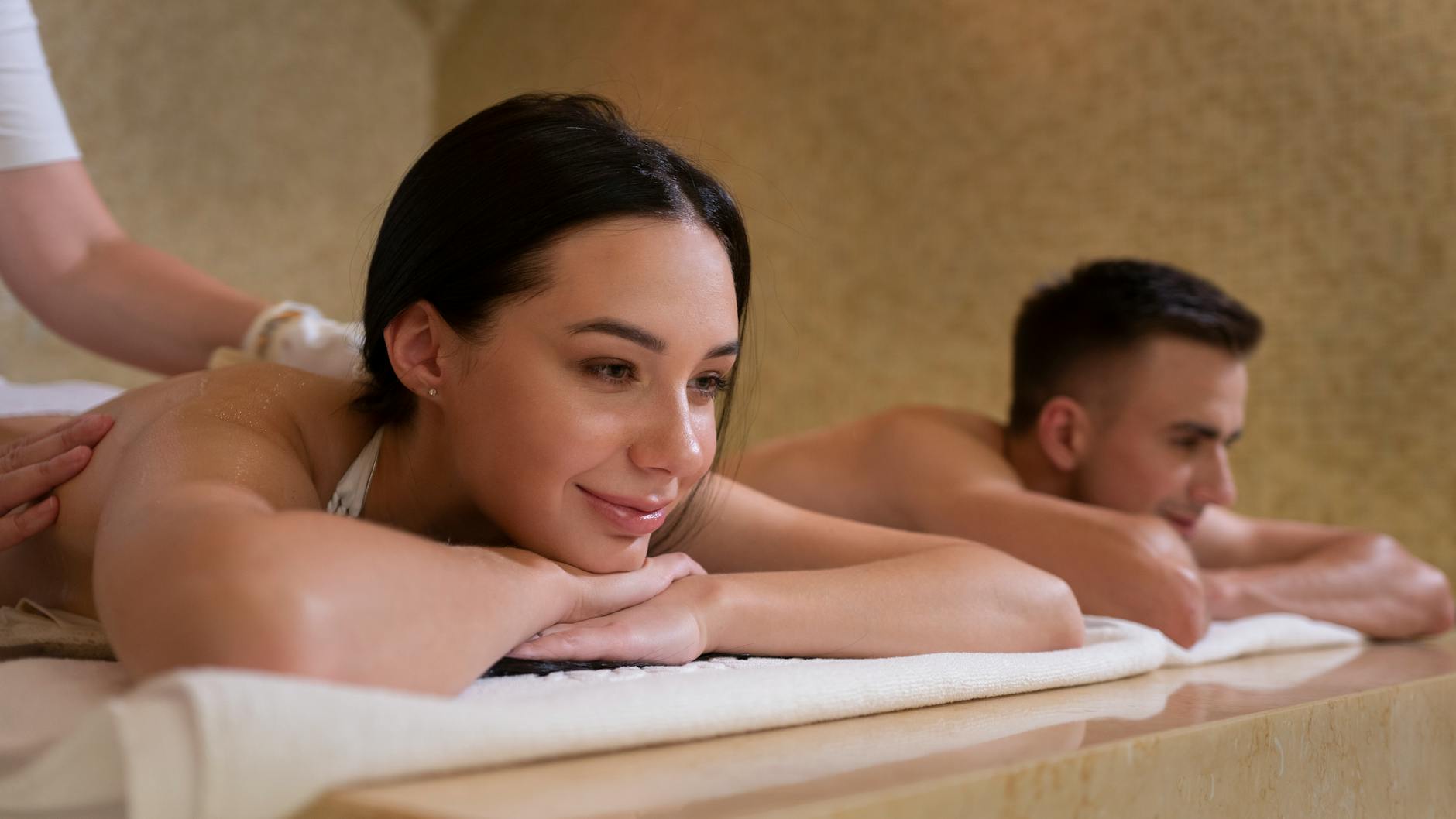 Couple receives relaxing massage treatment in serene spa setting. - couples therapy signs