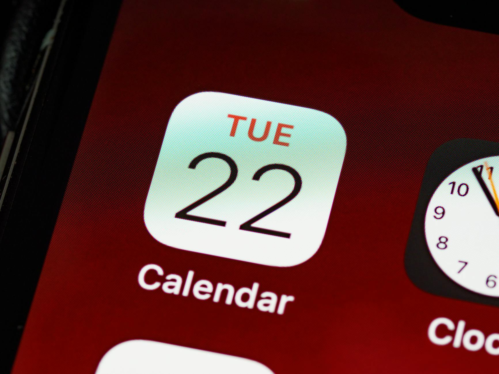 Detailed close-up of an iPhone home screen focused on the calendar app icon. - dating app refresh