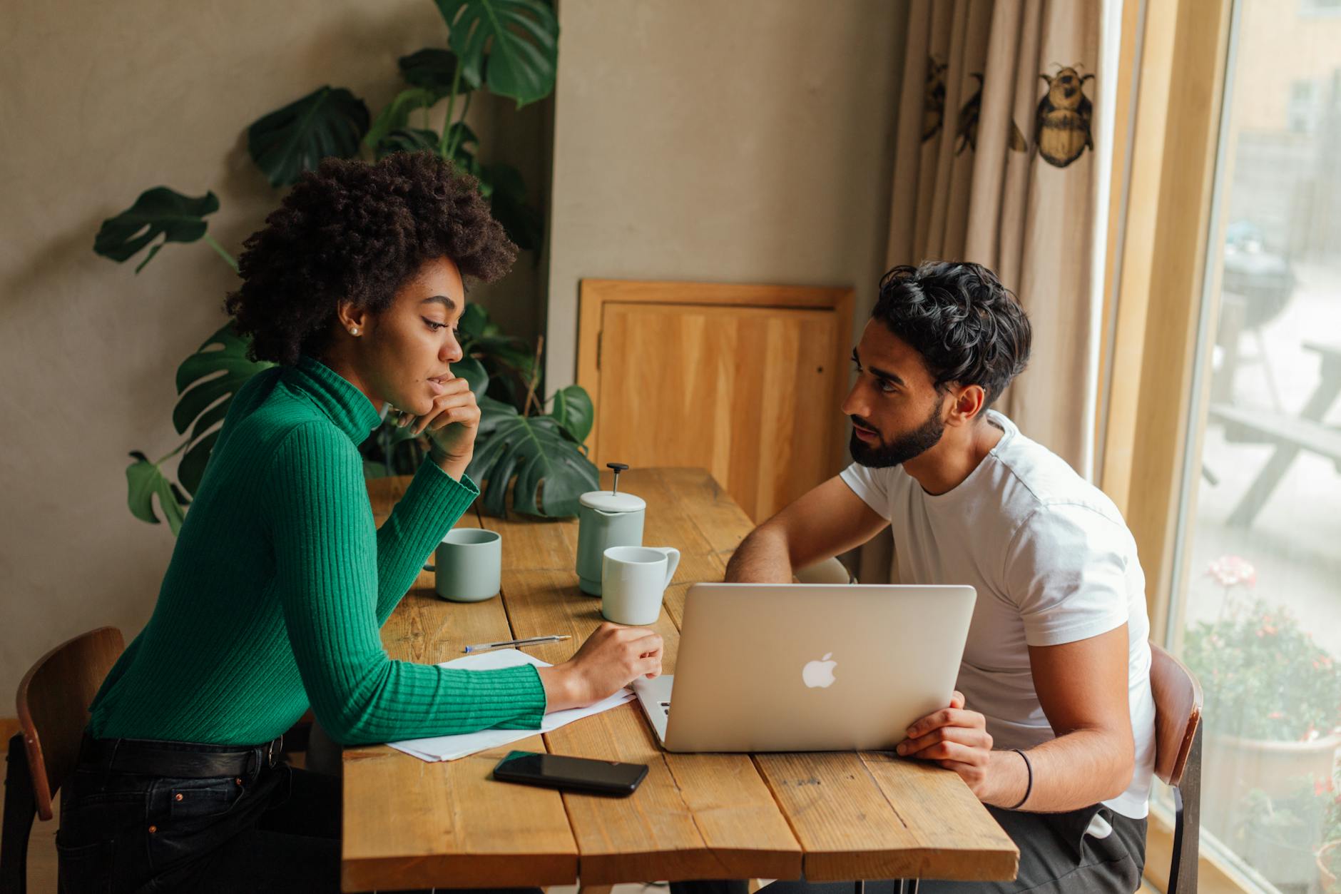 Two colleagues brainstorming and planning together using a laptop in a cozy office setting. - effective communication spring plans