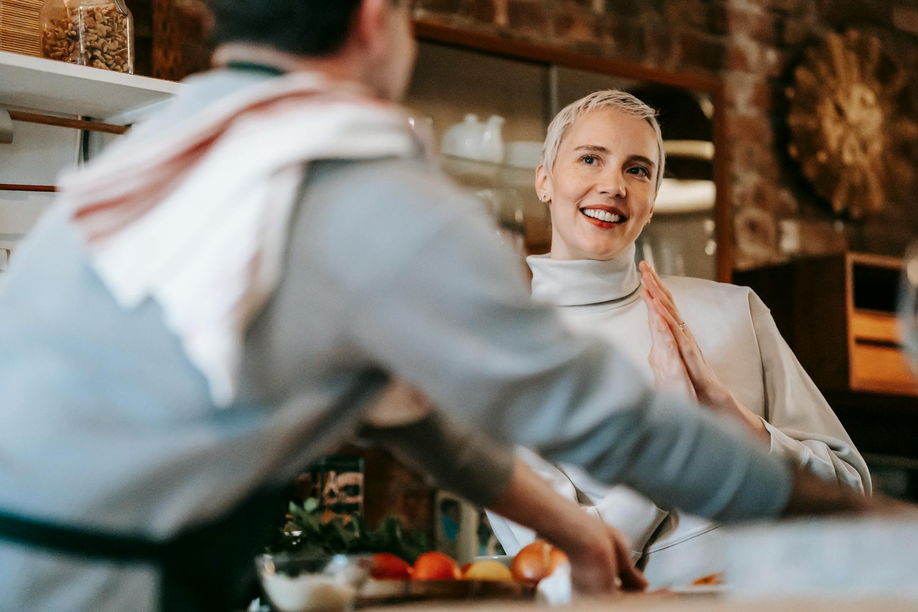 A happy couple enjoying their time cooking together in a cozy kitchen setting. - express gratitude partner