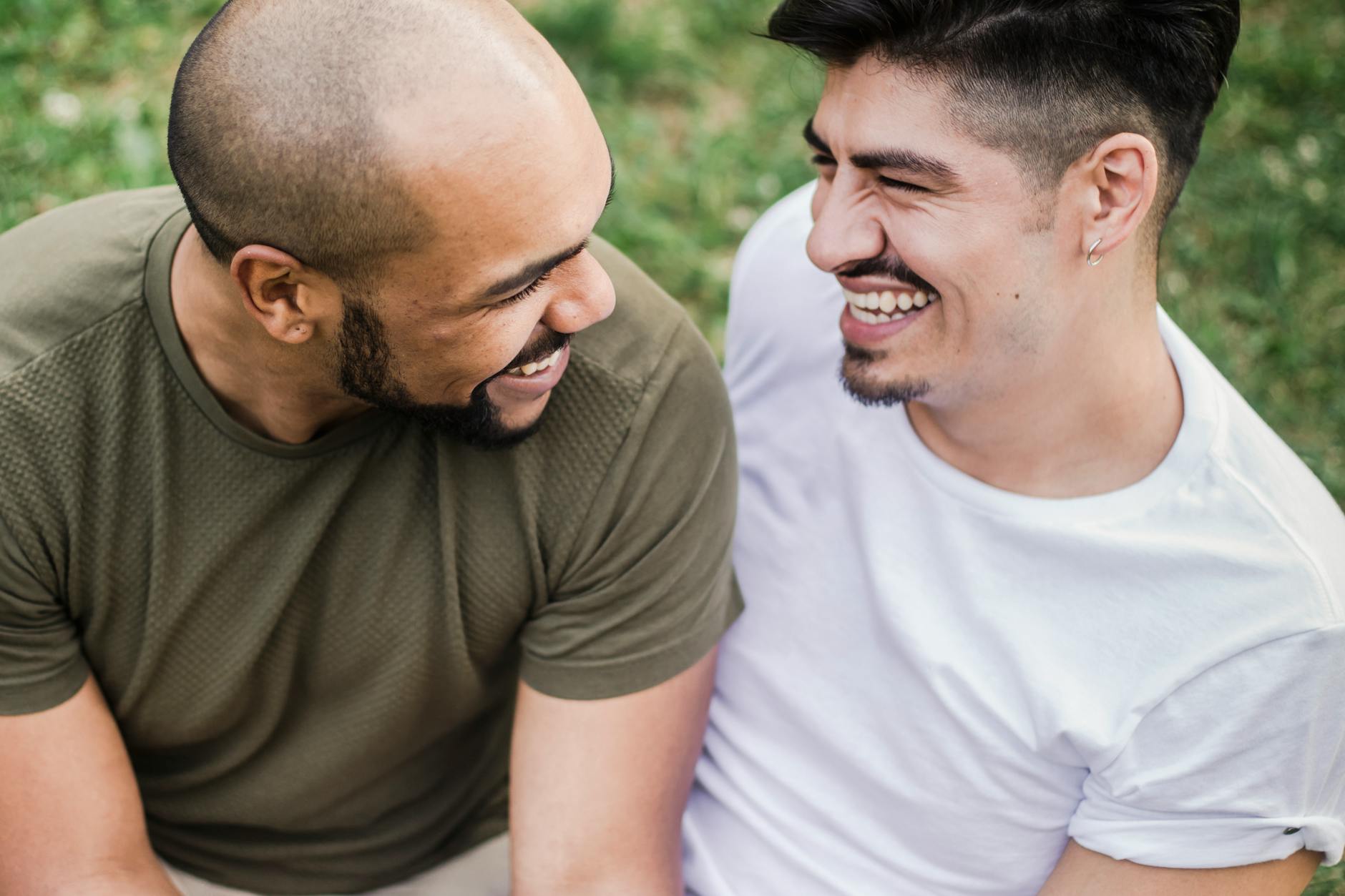 Interracial gay couple sharing a joyful moment outdoors, full of happiness and connection. - express needs couples