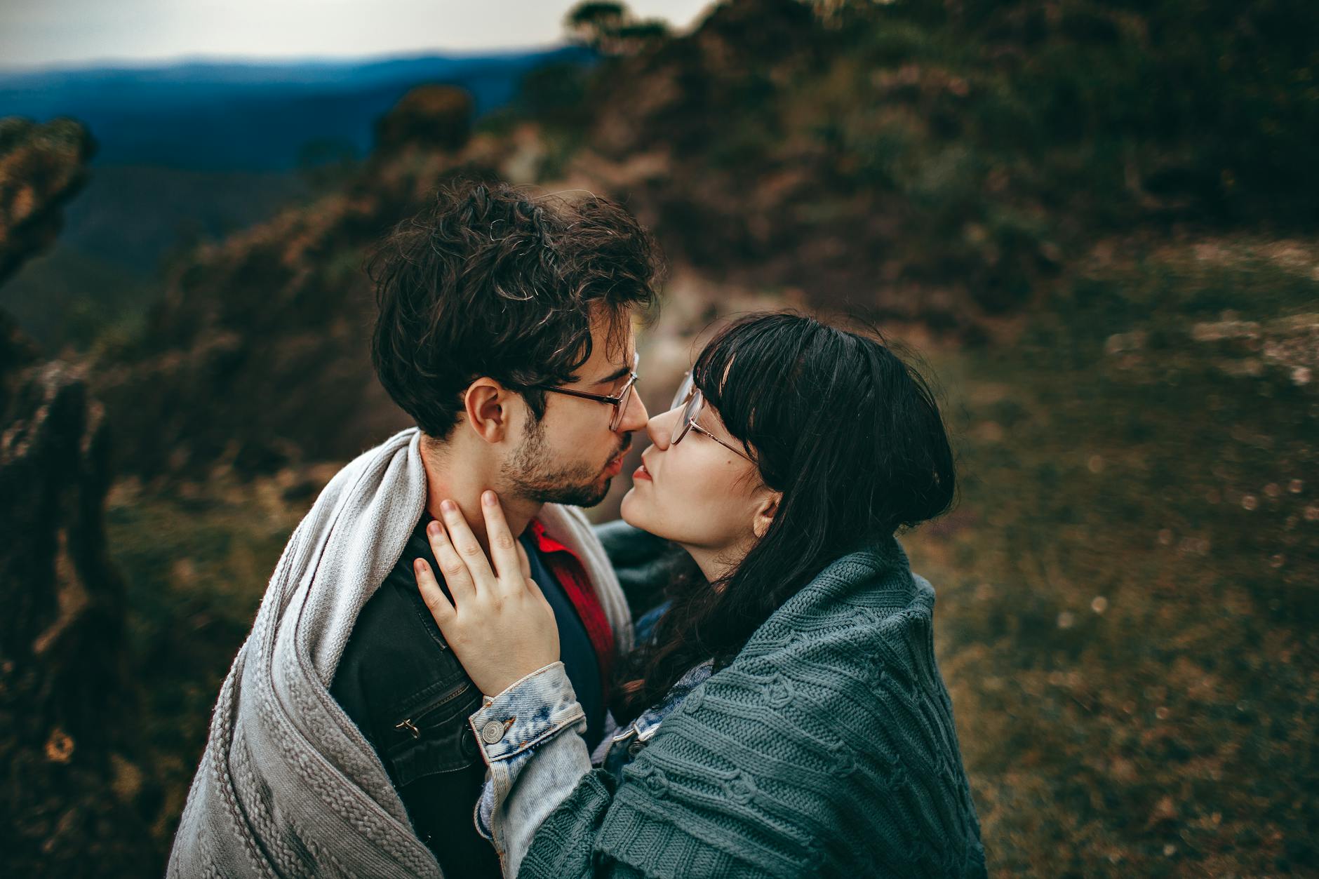 Young couple sharing an intimate embrace in a scenic outdoor setting in Brazil, showcasing love and romance. - express needs couples
