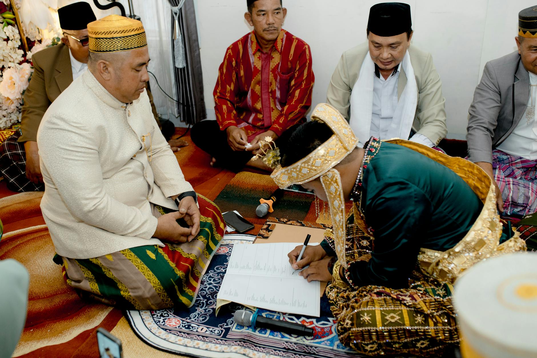 Traditional marriage contract signing in South East Sulawesi, Indonesia, with participants in cultural attire. - express needs marriage