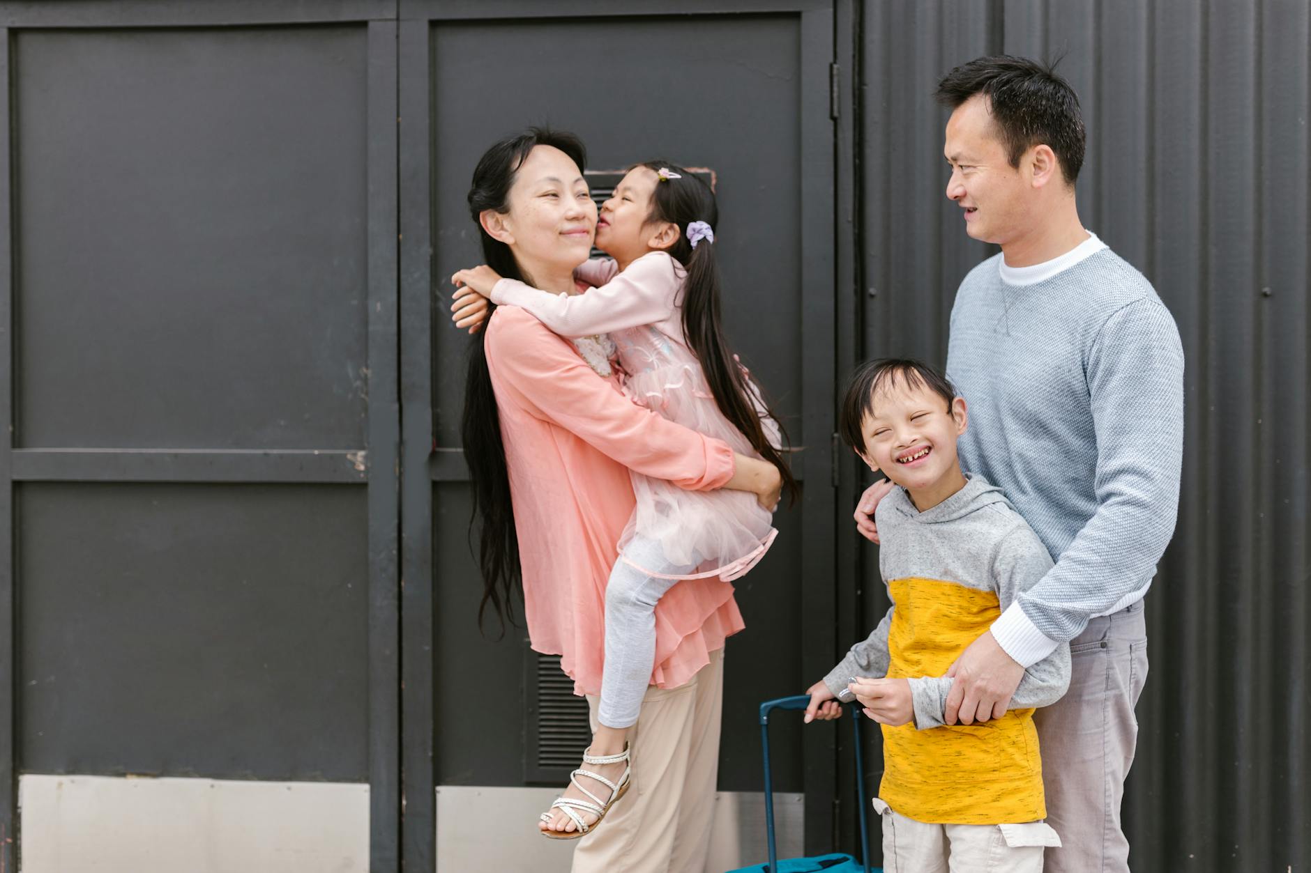 Asian family embracing and enjoying time together outdoors, showcasing love and inclusion. - express relationship needs