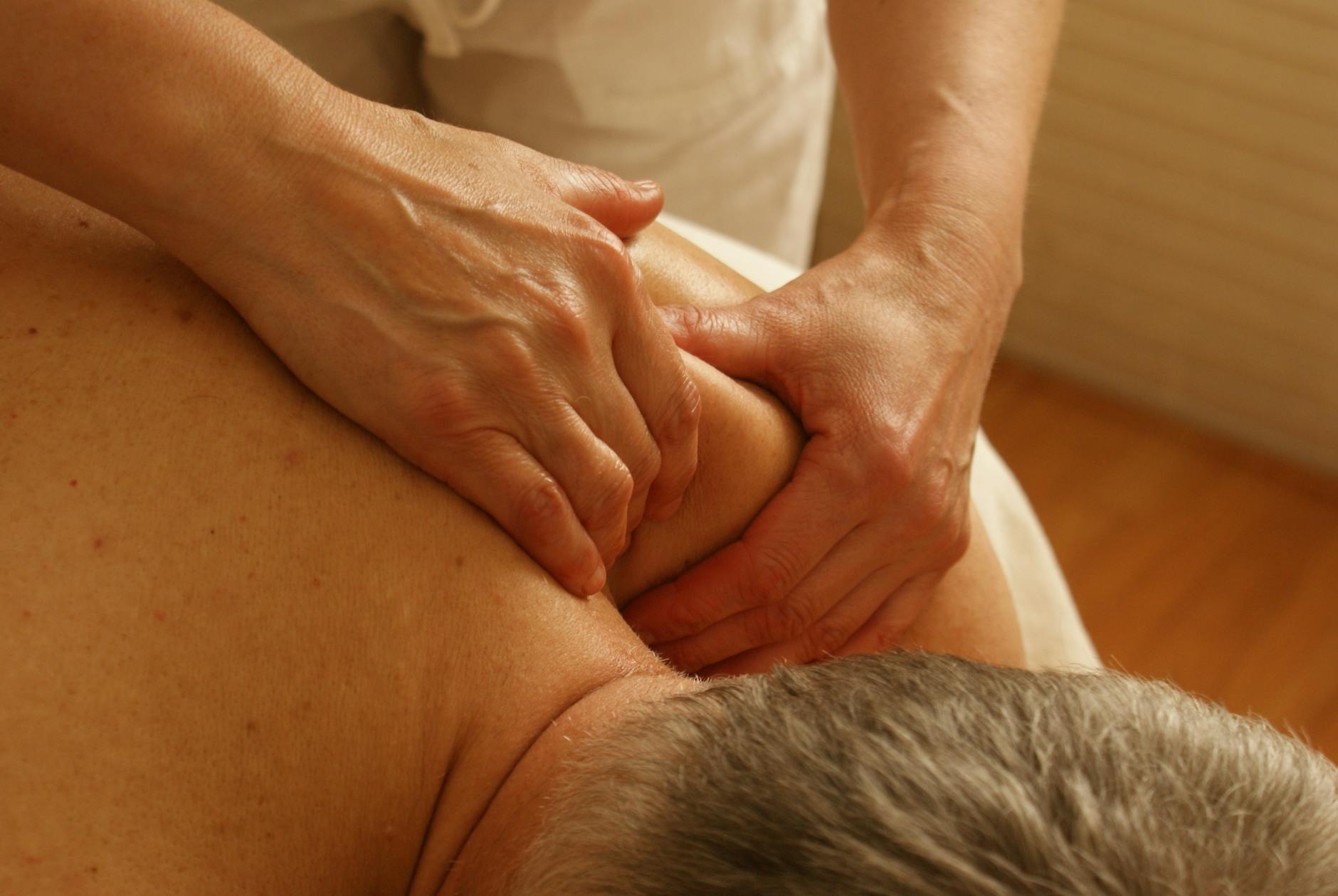 Close-up of a therapist giving a relaxing shoulder massage, enhancing wellness and stress relief. - family dynamics therapy