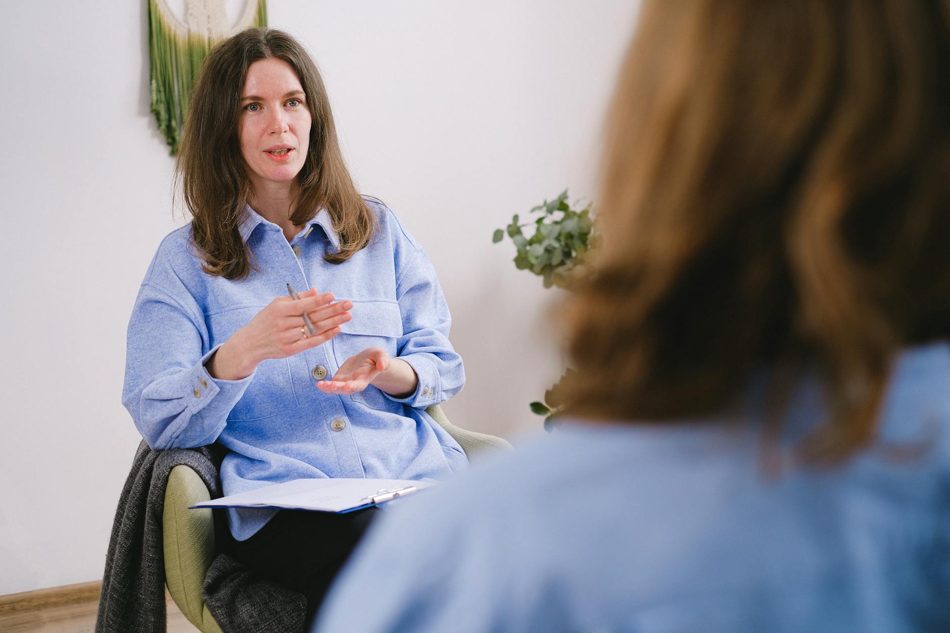 A therapist interacts with a patient during a counseling session, highlighting empathy and communication. - find a therapist