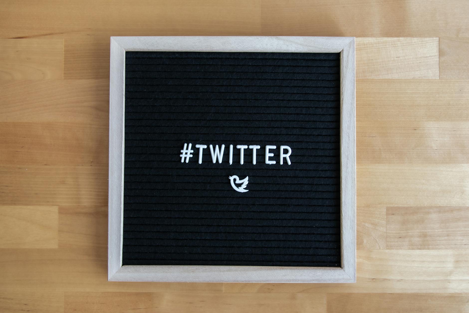 Black letter board with #Twitter hashtag and bird icon, ideal for social media themes. - first message online dating