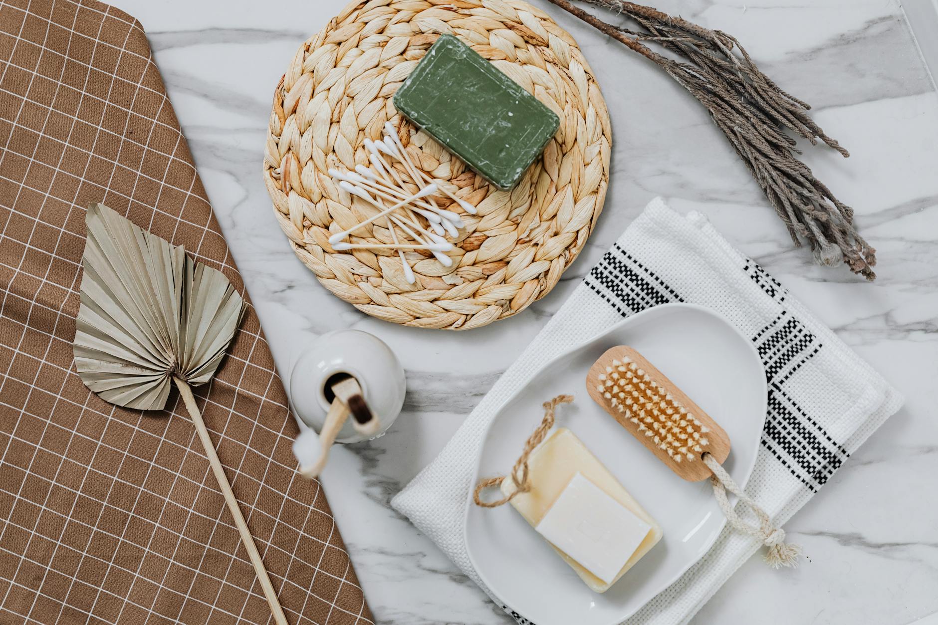 Eco-friendly bath items including soap and q-tips on a stylish flat lay. - funny marriage tips