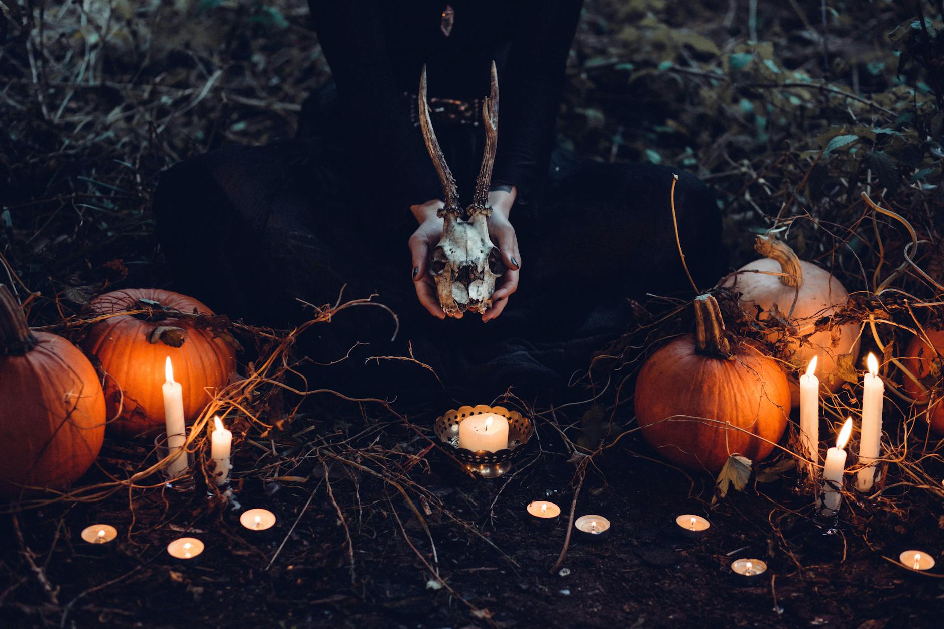 Eerie Halloween scene with pumpkins, candles, and a skull. Perfect for creating a spooky atmosphere. - funny marriage tips