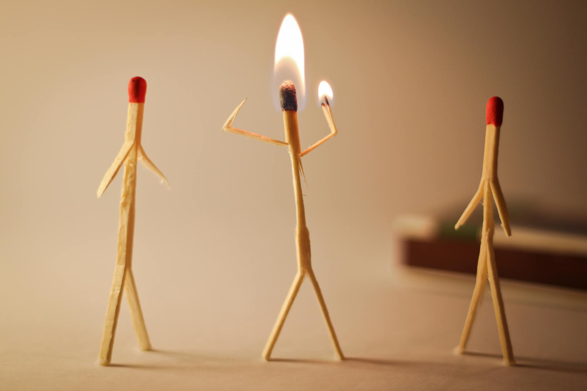 Artistic matchstick figures arranged with flames showcasing creativity and craftsmanship. - gaslighting examples
