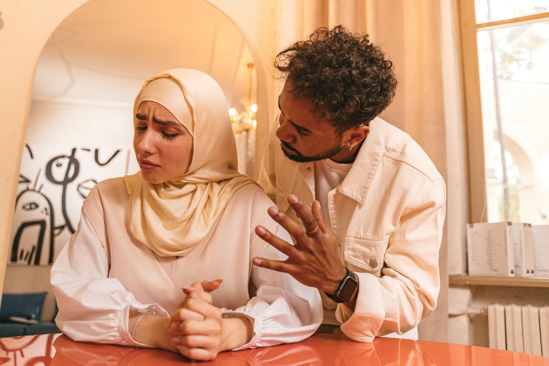 A tense moment between a man and woman indoors, highlighting relationship conflict. - gaslighting examples