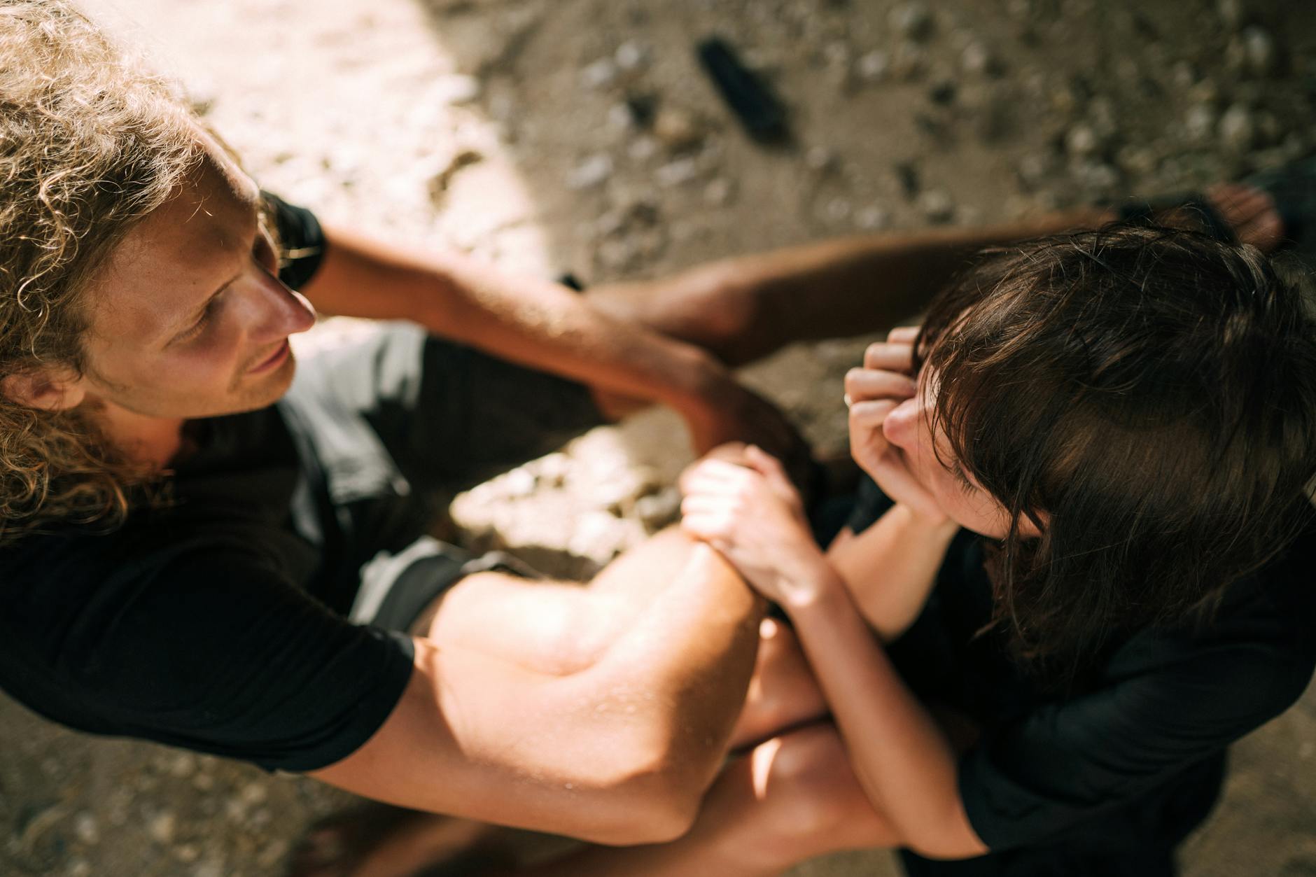 A couple sitting closely together on a sunny beach, sharing a tender moment. - healthy relationship communication