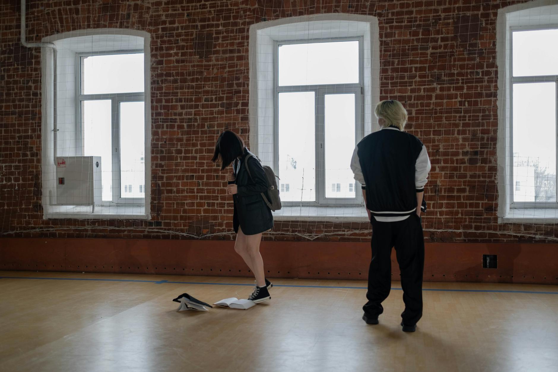 A boy intimidates a girl in a school hallway, depicting a bullying scenario. - managing family conflict spring holidays