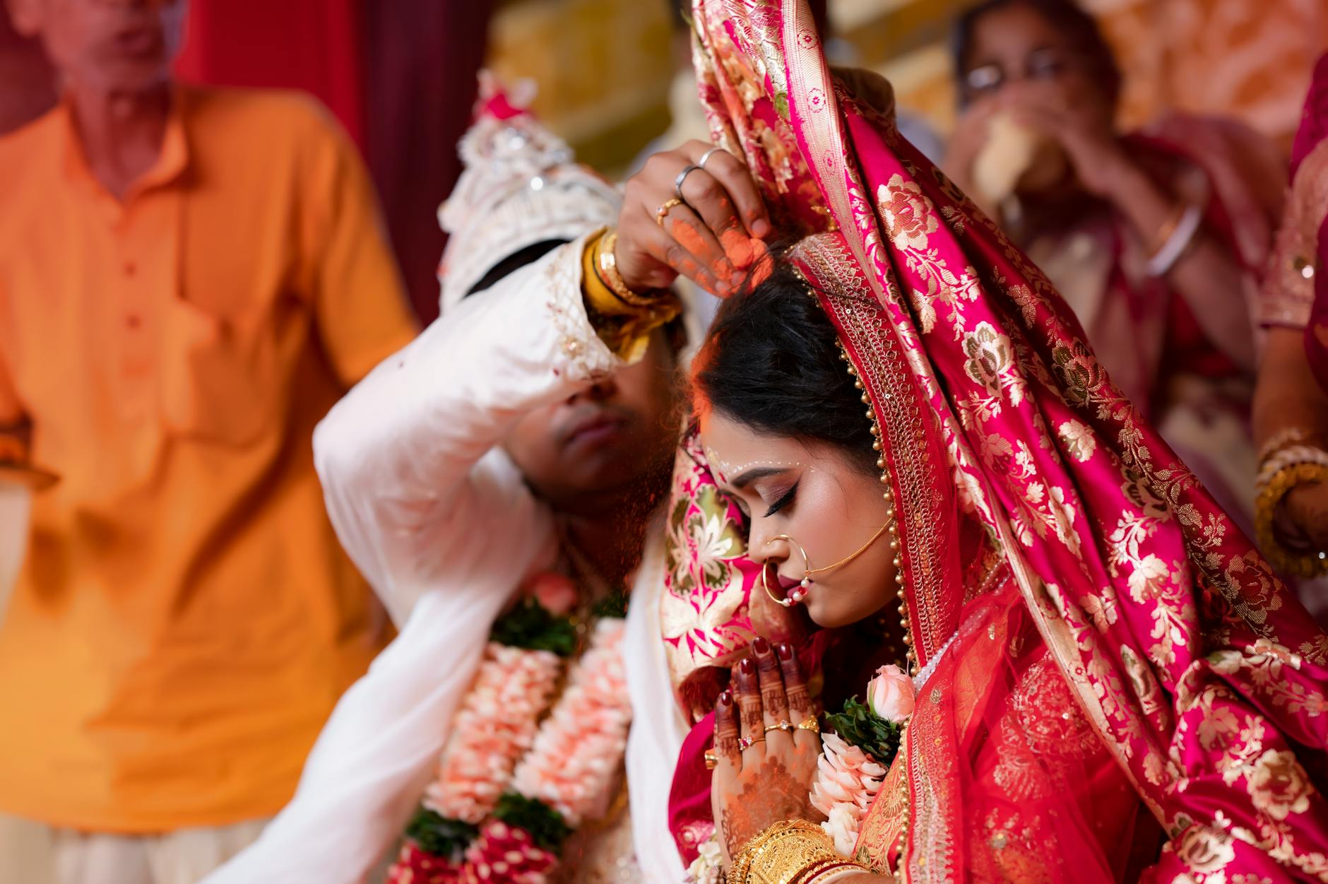 Bride and groom perform traditional wedding rituals in a vibrant cultural ceremony. - marriage advice bride