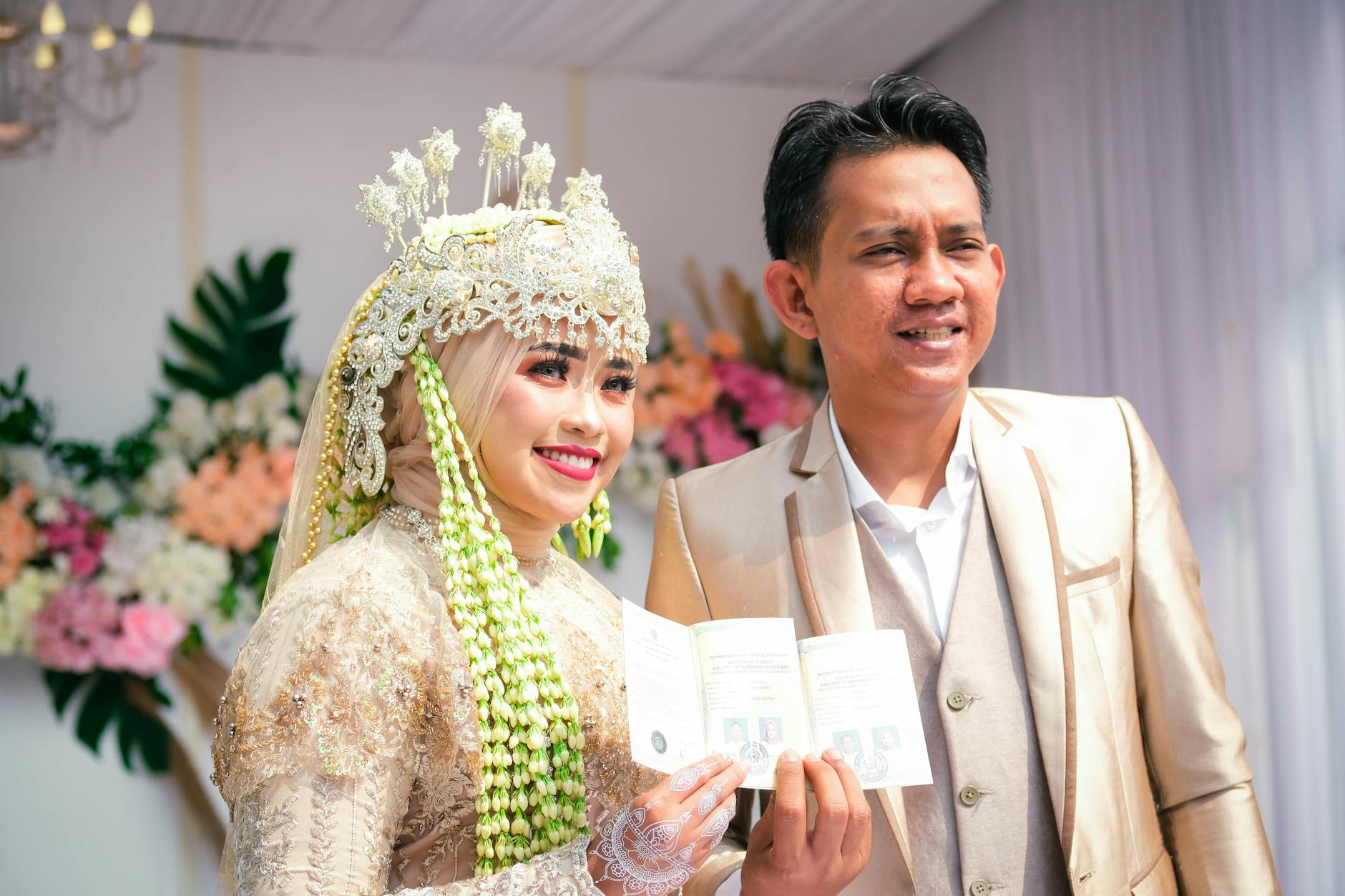 Smiling Indonesian Muslim couple in traditional attire during their joyful wedding celebration. - marriage advice bride