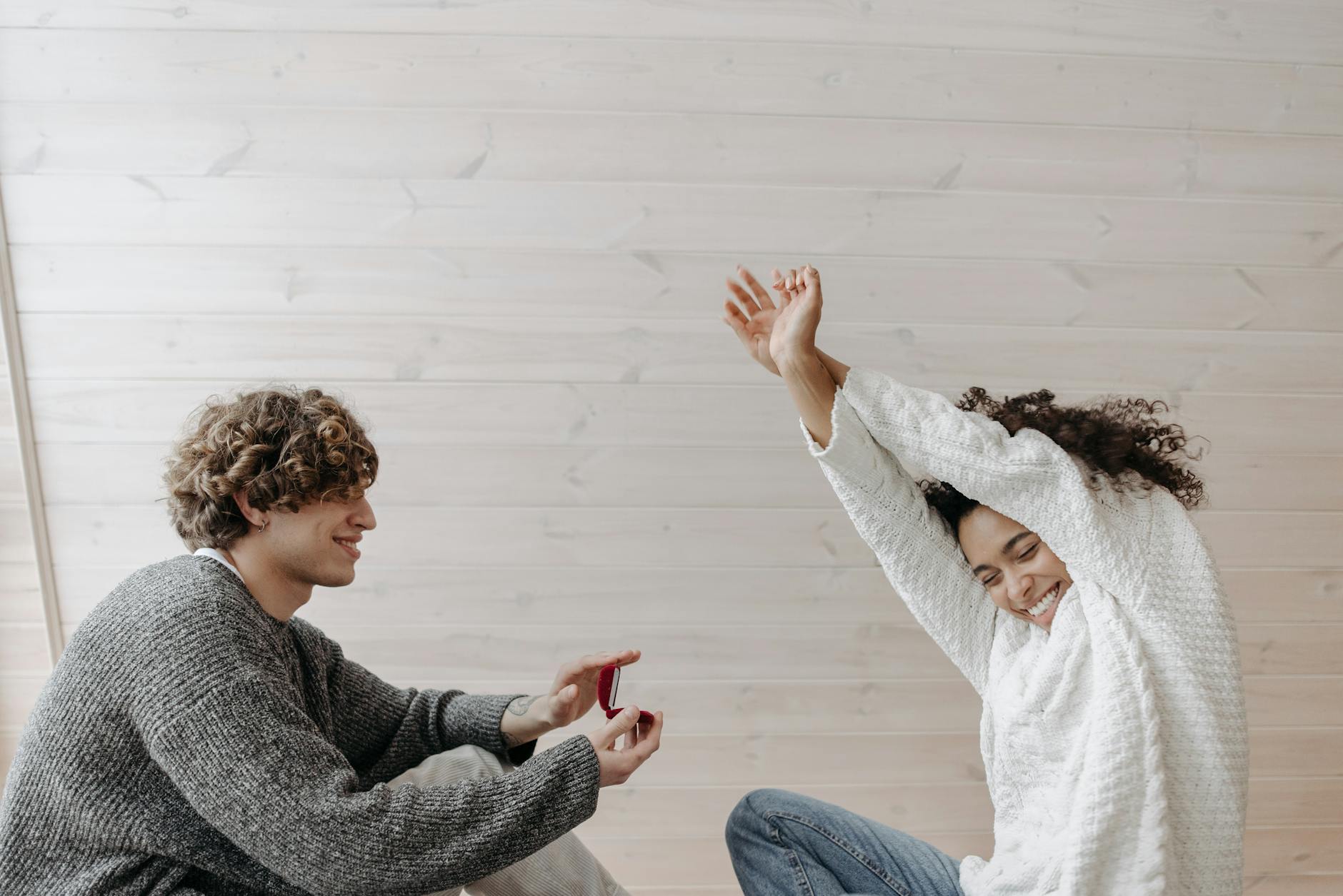 A happy couple during a marriage proposal, showcasing joy and love indoors. - marriage communication tips
