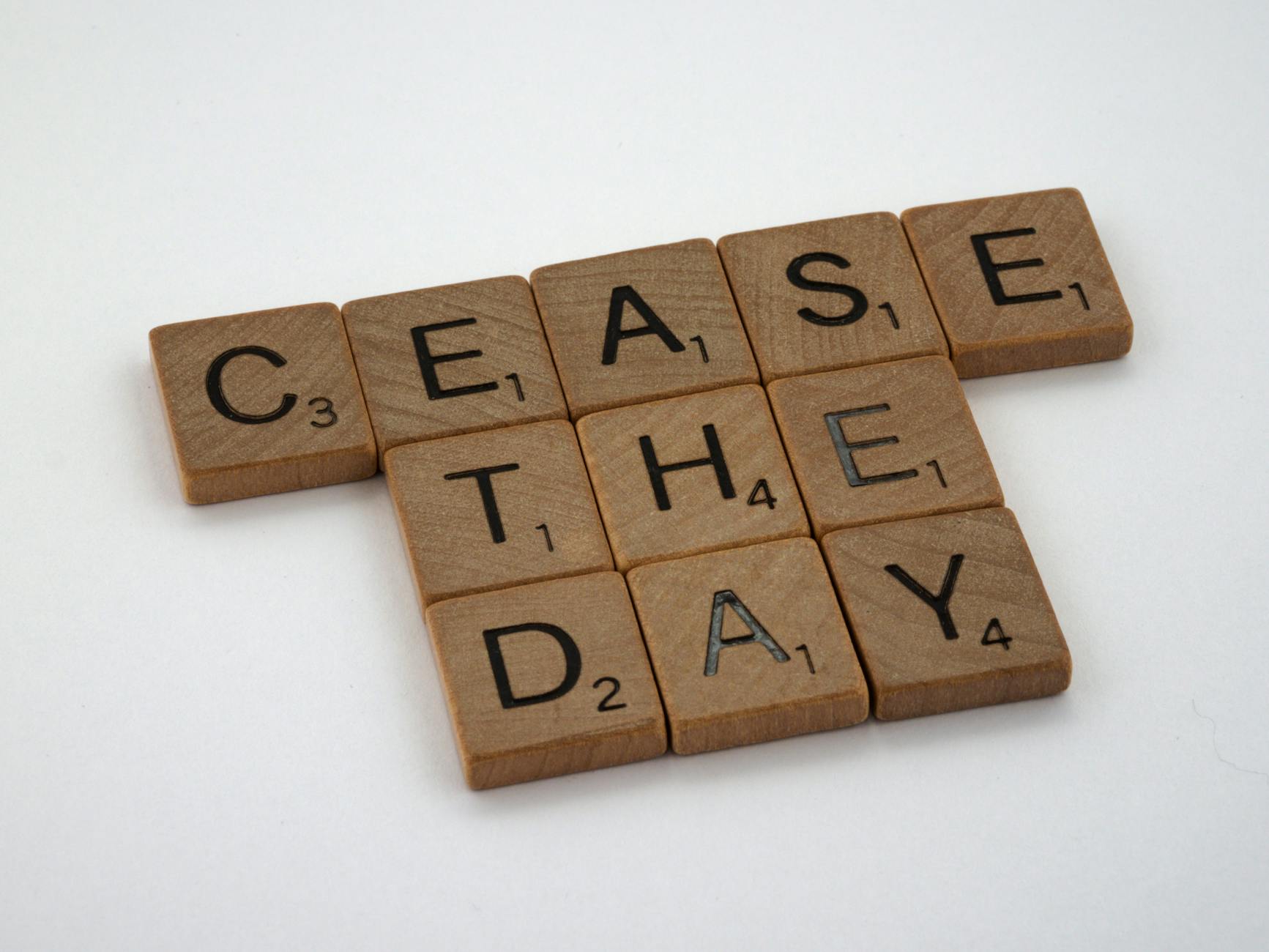 Scrabble tiles arranged to spell 'Cease The Day', creating a playful twist on a popular slogan. - overcome procrastination