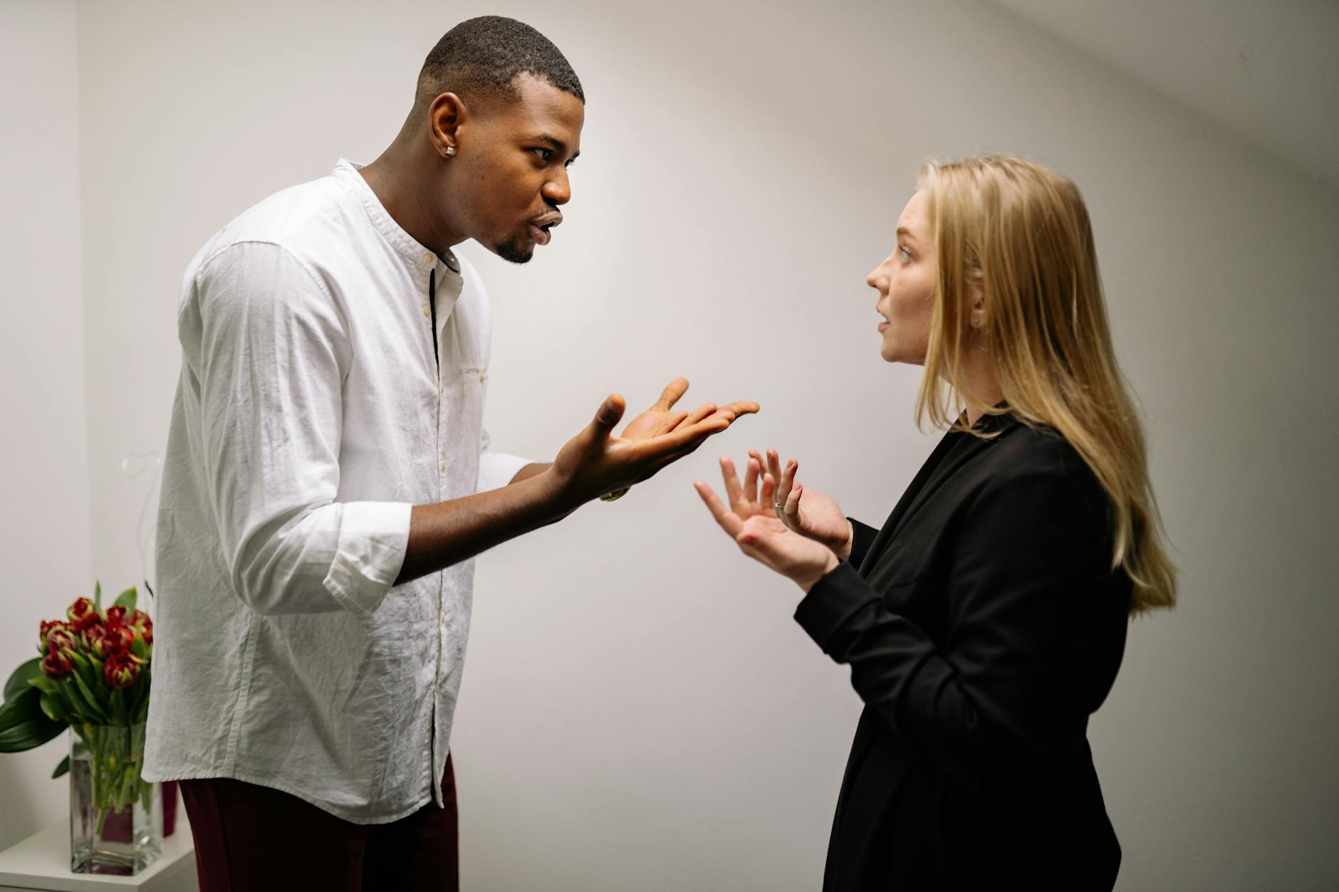 A man and woman engaged in a heated office argument, displaying emotion and intensity. - partner needs communication