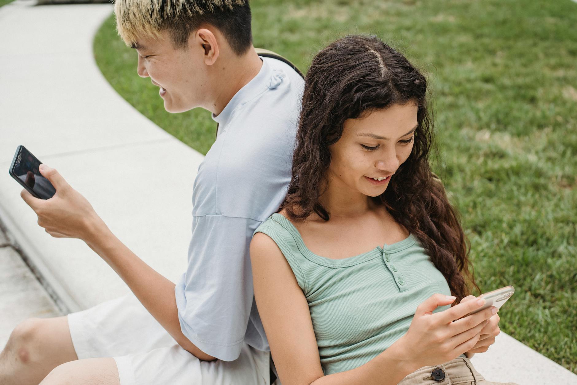 Happy couple enjoying leisure time on their smartphones outdoors. - partner needs communication
