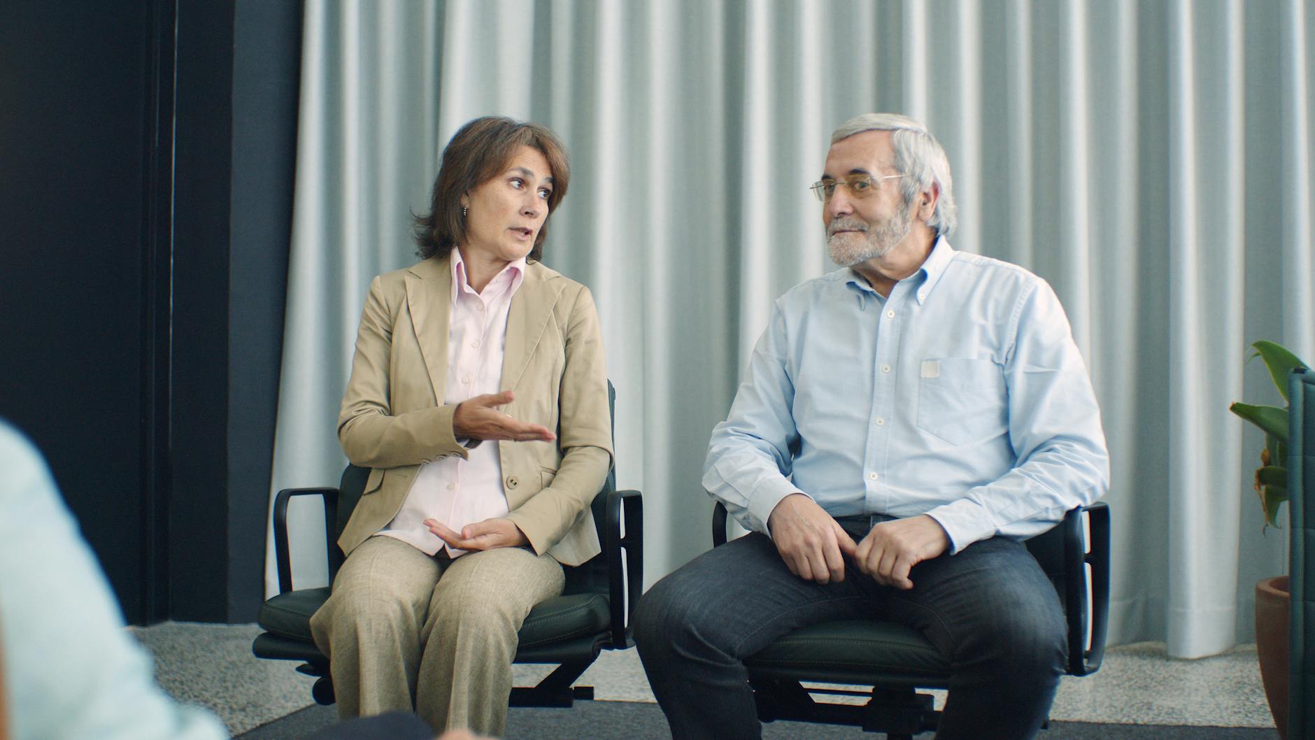 An elderly couple sitting in a counseling session discussing their relationship. - pre-marriage counseling