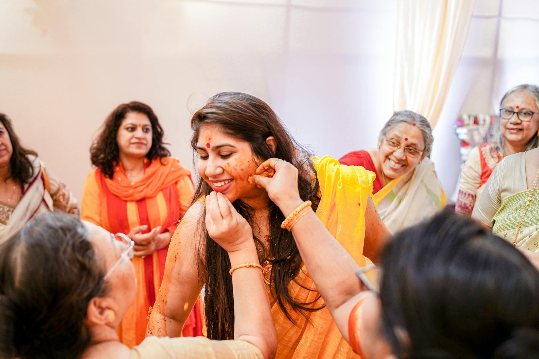 A vibrant Indian haldi ceremony with joyful family moments captured indoors. - pre-marriage counseling