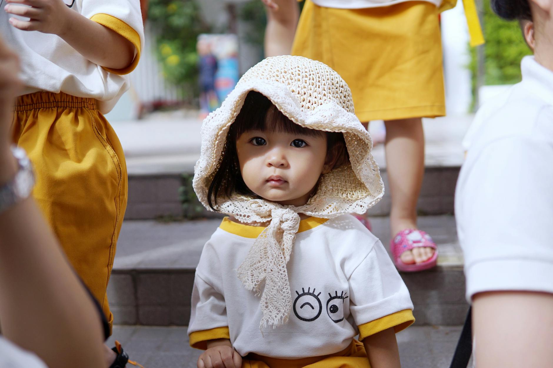 Adorable young girl in school uniform and knitted hat outdoors. - preschool playdate etiquette