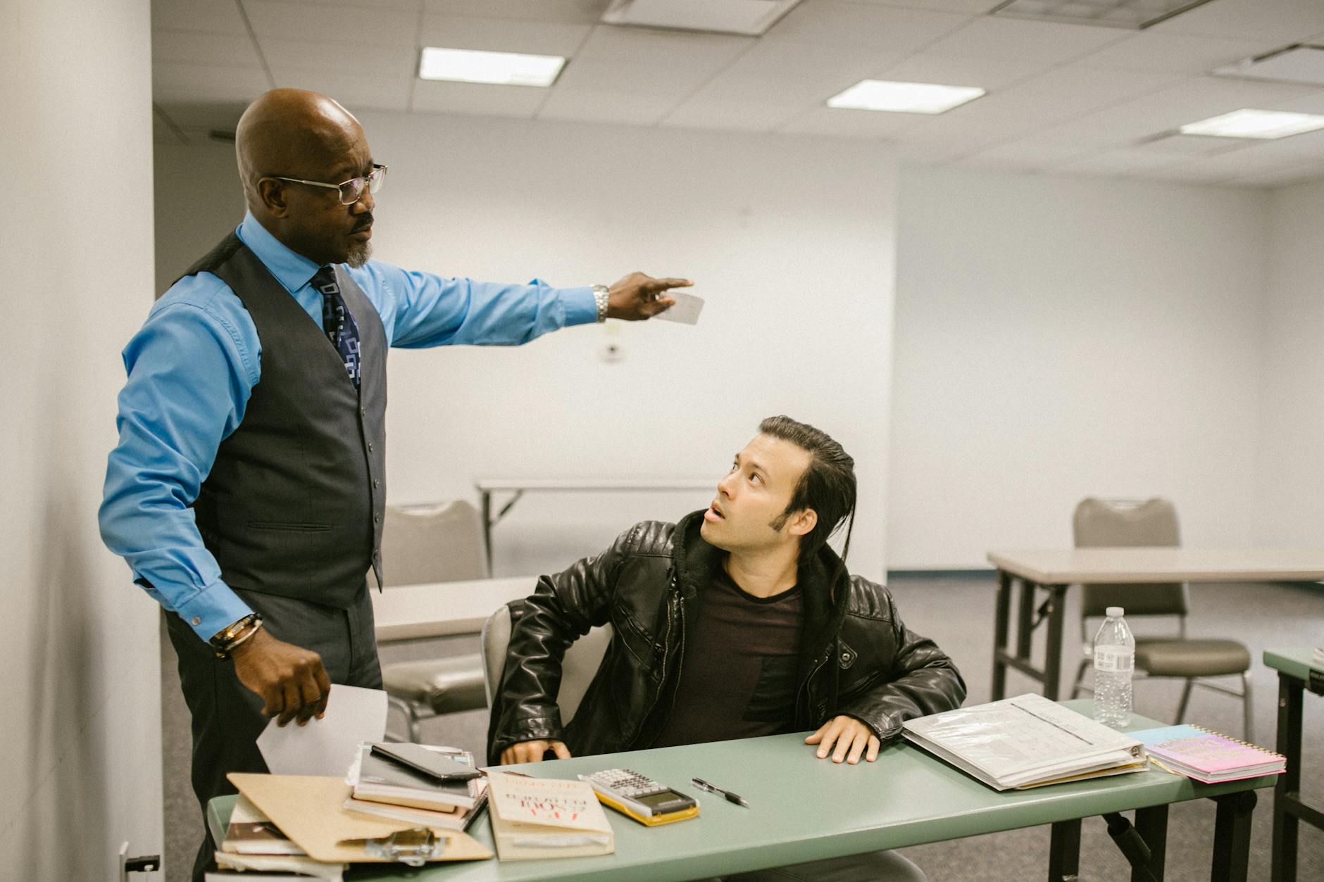 A teacher reprimands a student in a classroom, highlighting issues of academic integrity. - rebuilding trust cheating