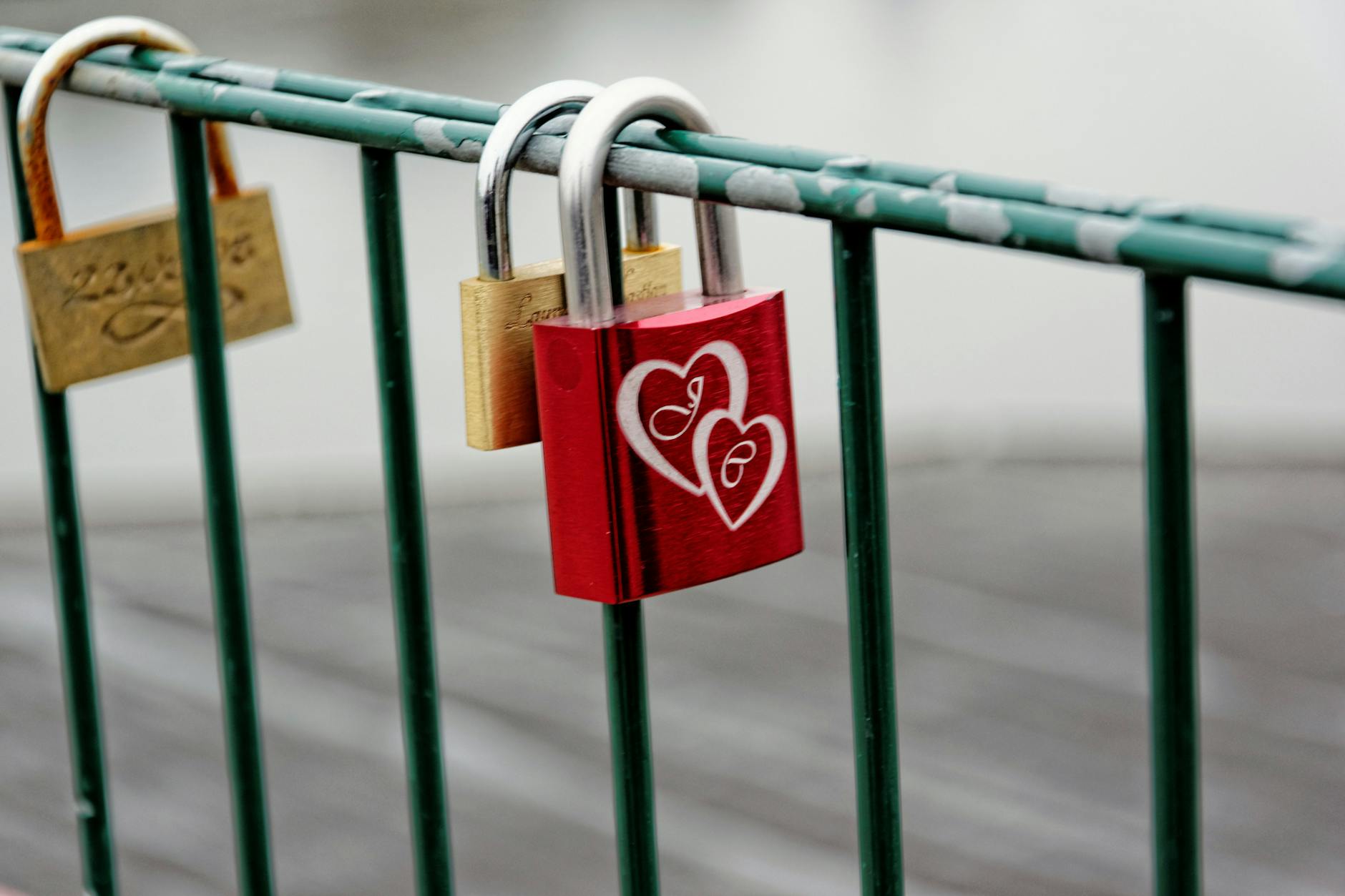 A vibrant red love padlock with heart engravings on a bridge railing symbolizing eternal love. - reconnecting with partner