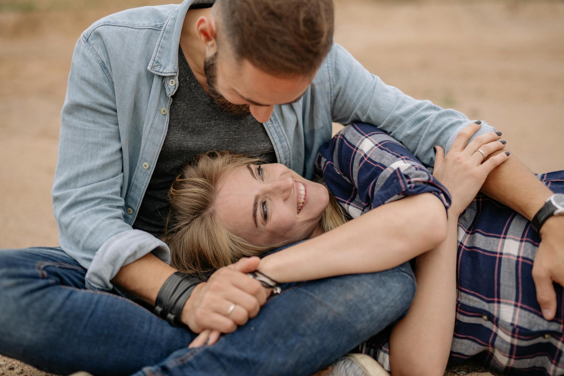 A loving couple embraces outdoors, smiling and relaxed in casual attire, depicting affection and happiness. - rekindle intimacy long term relationships