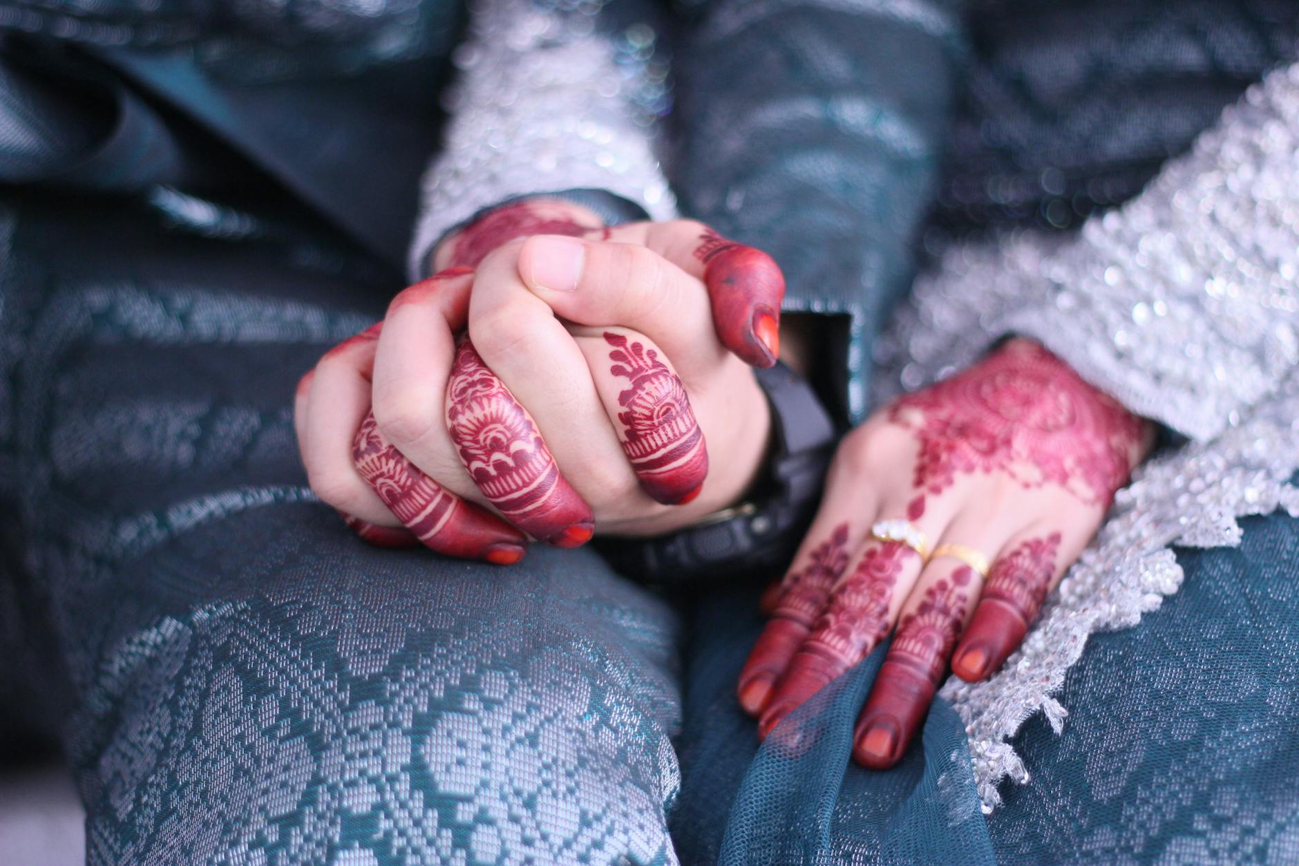 Elegant close-up of a couple's hands adorned with henna, symbolizing love in a traditional ceremony. - rekindle marital intimacy