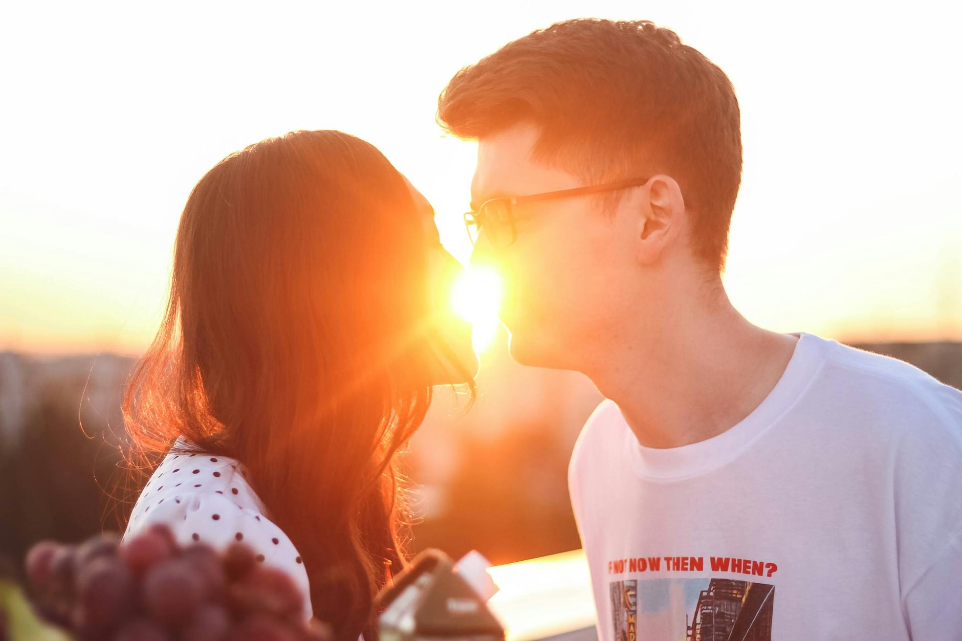 A couple shares a kiss at sunset, creating a warm, romantic scene filled with love and light. - rekindle romance