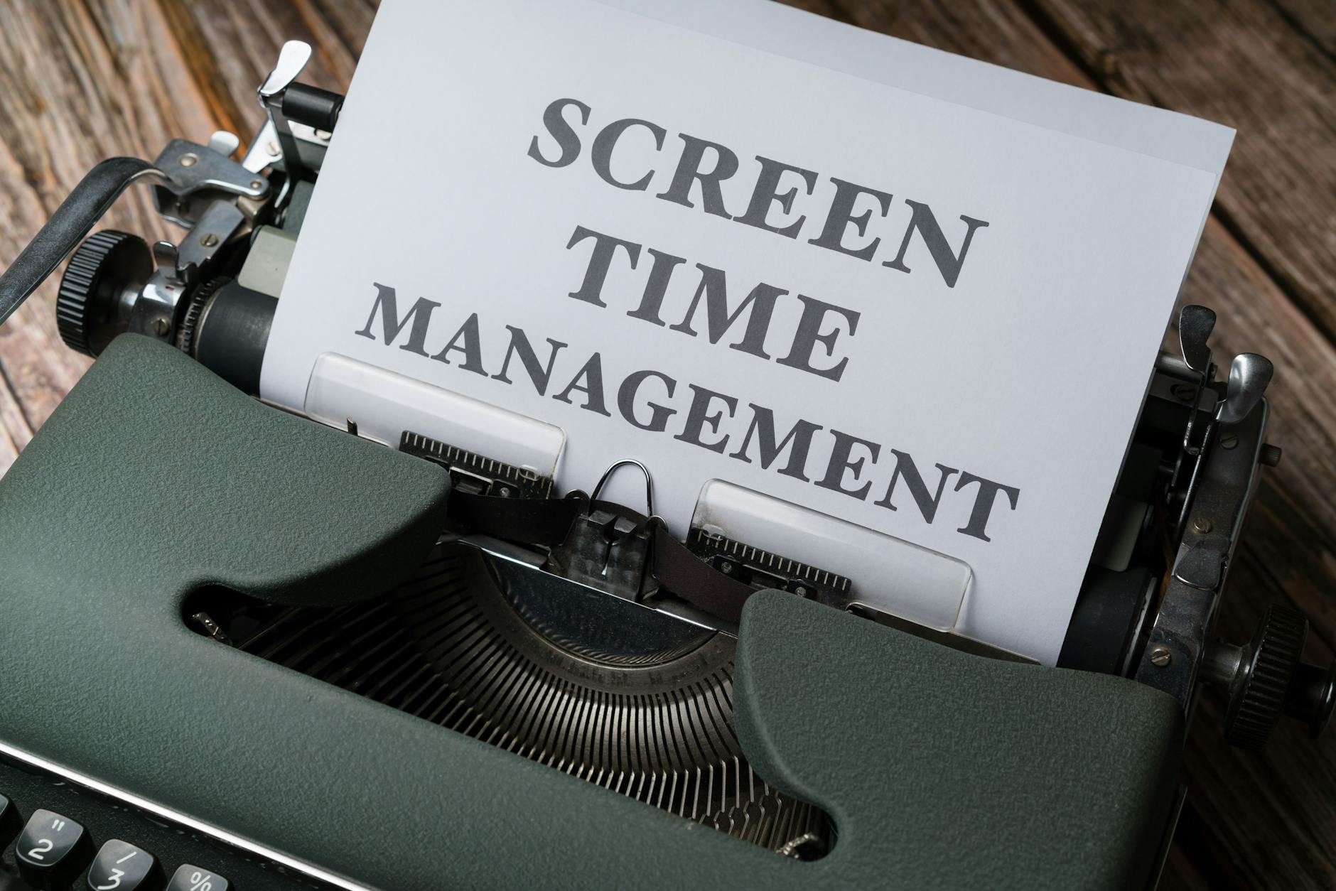Vintage typewriter with 'Screen Time Management' printed on paper, emphasizing digital wellness. - screen time balance