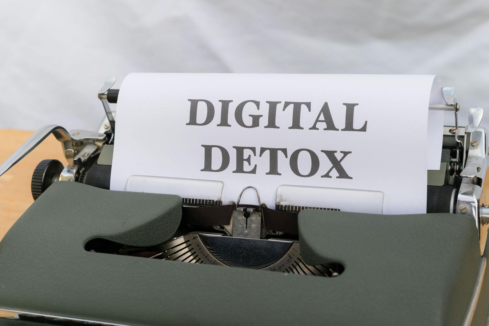 Close-up of a typewriter with paper showing 'Digital Detox', emphasizing a tech-free lifestyle. - screen time balance