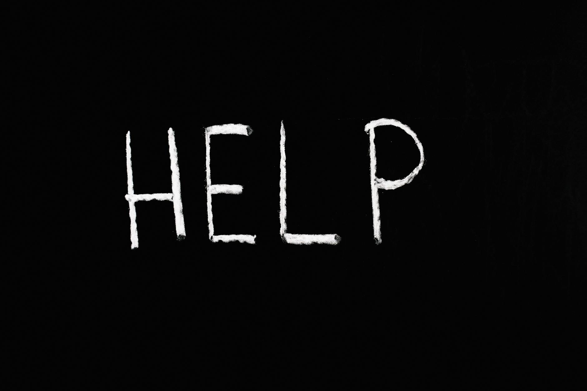Chalk-written 'HELP' on a deep black background symbolizes assistance and encouragement. - sexless marriage help