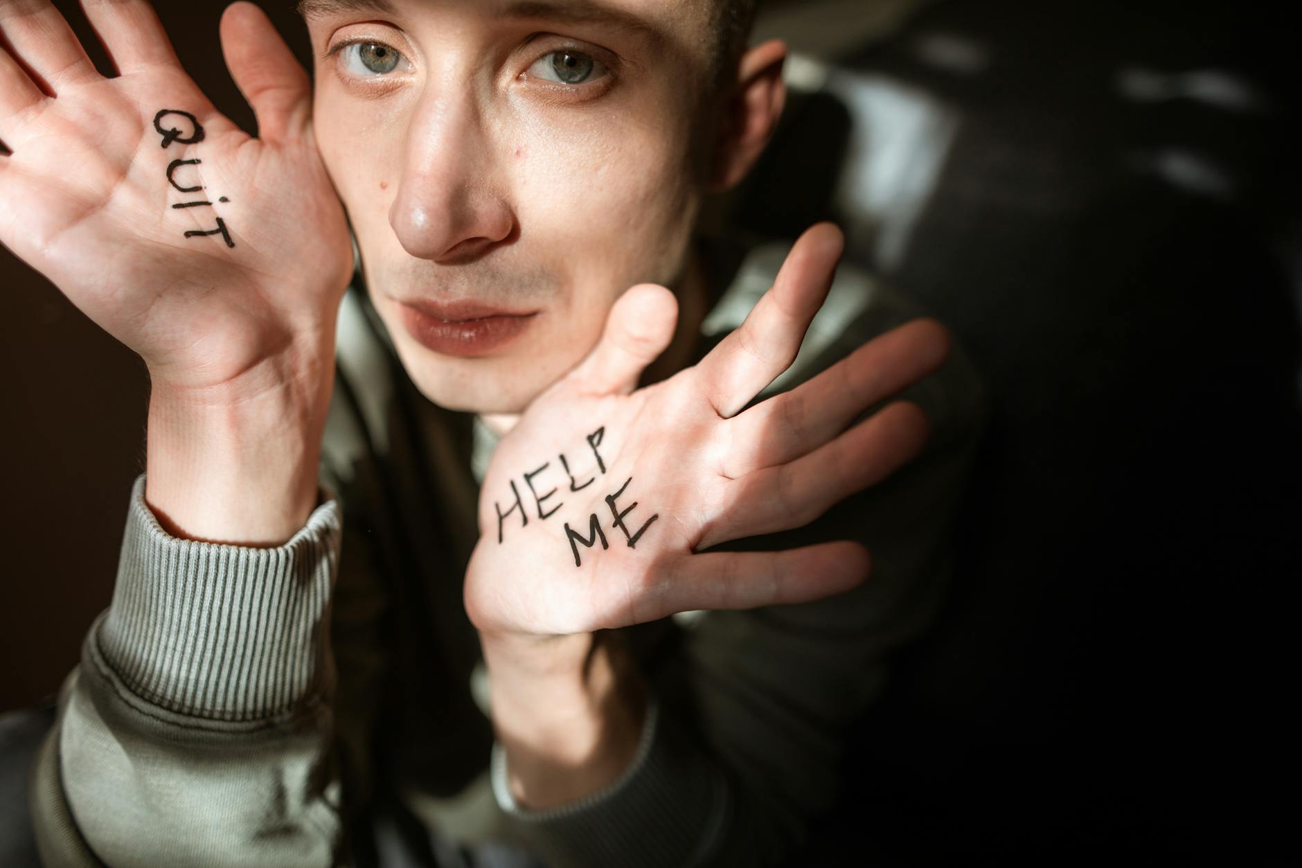 Close-up of a person showing palms with 'Help Me' and 'Quit' written, expressing emotions. - sexless marriage help
